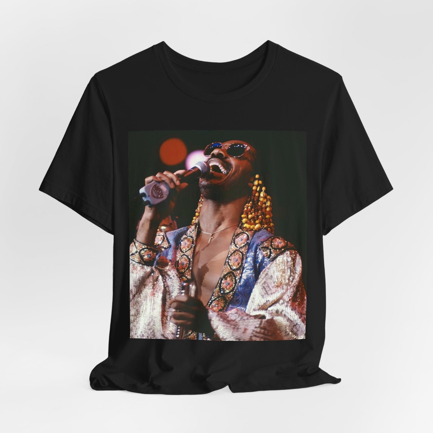 A black graphic t-shirt featuring a 70s vintage soul icon graphic of Stevie Wonder.