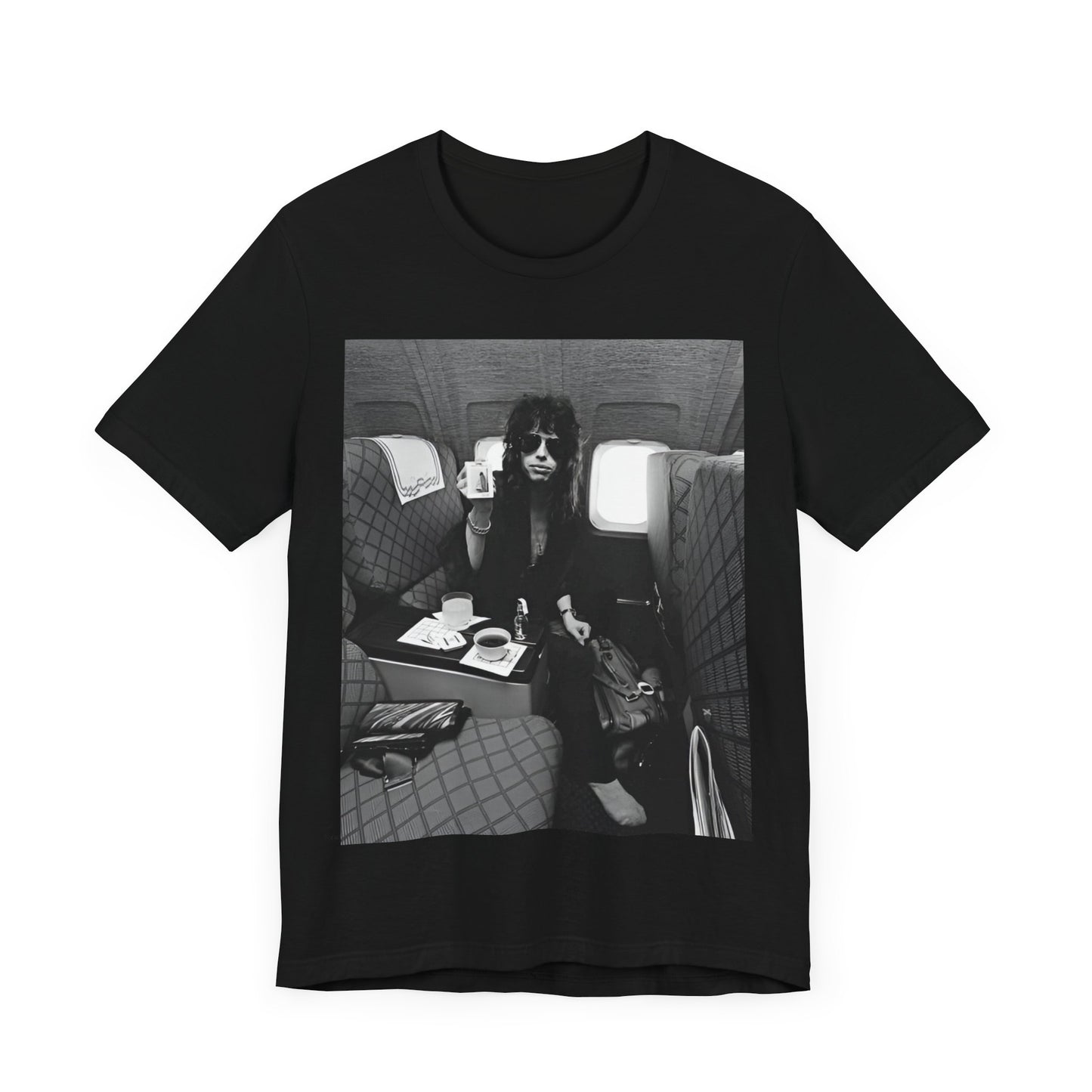 A black graphic t-shirt featuring a vintage 70s-style illustration of an airplane with Aerosmith branding, representing their tour plane from that era.
