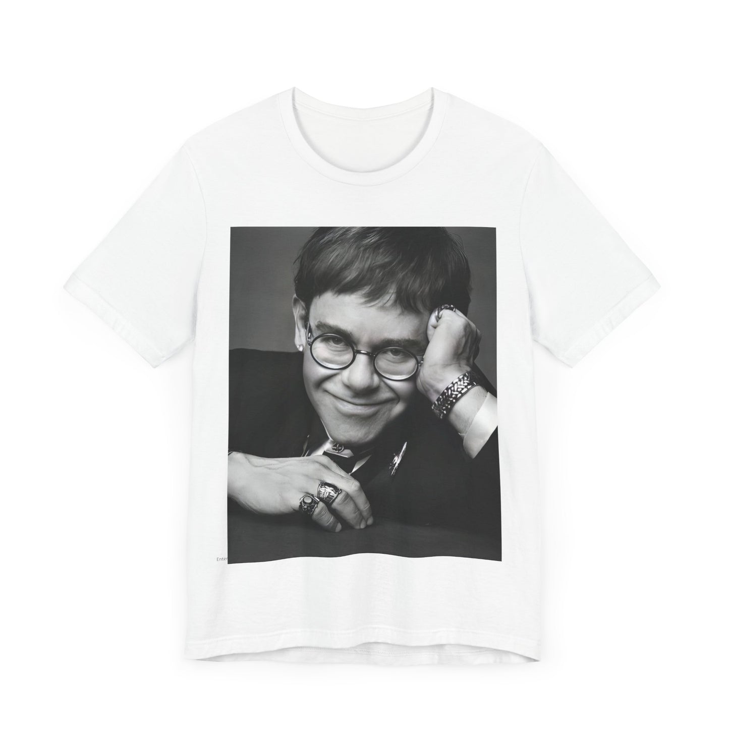 A black graphic t-shirt featuring a retro black and white photo portrait of Elton John.