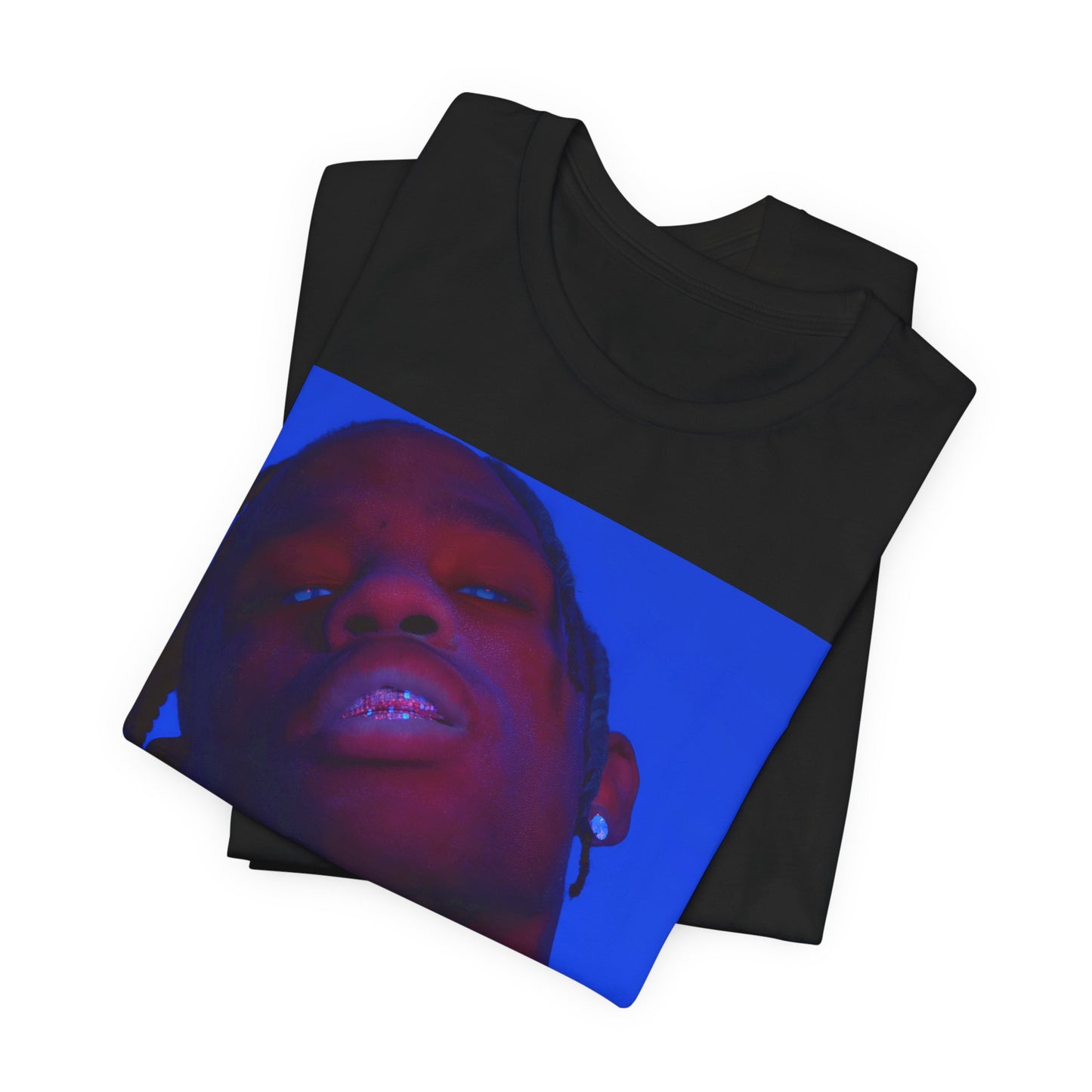 A black graphic t-shirt featuring a bold graphic of Travis Scott as a rap superstar.