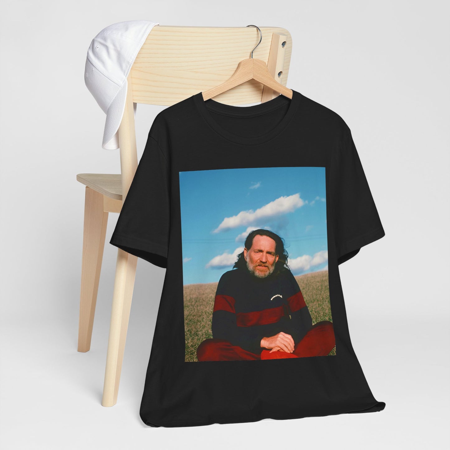 A black graphic t-shirt featuring a classic outlaw country graphic of Willie Nelson.