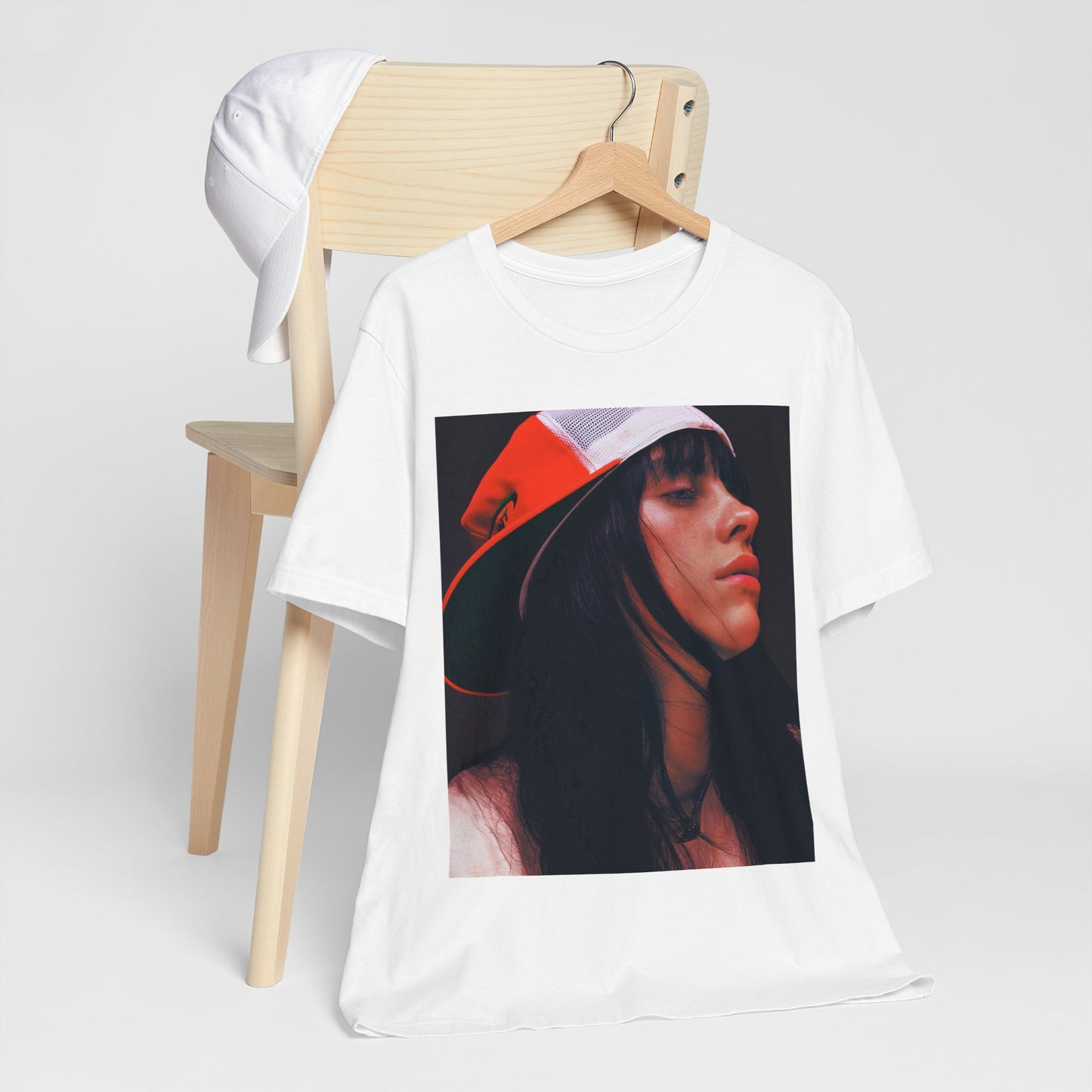 A graphic t-shirt featuring the name 'Billie Eilish' in a raw, urban street-style font.