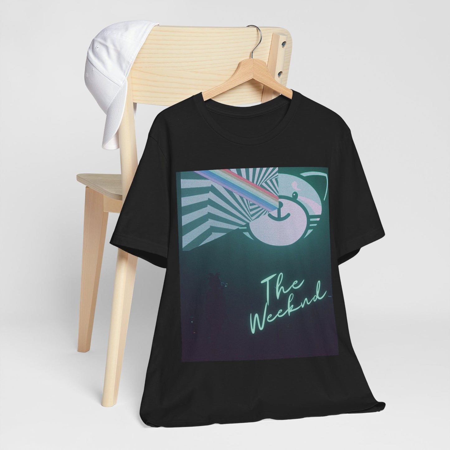 A black graphic t-shirt featuring a vintage concert graphic of The Weeknd from his 'Kiss Land' era.
