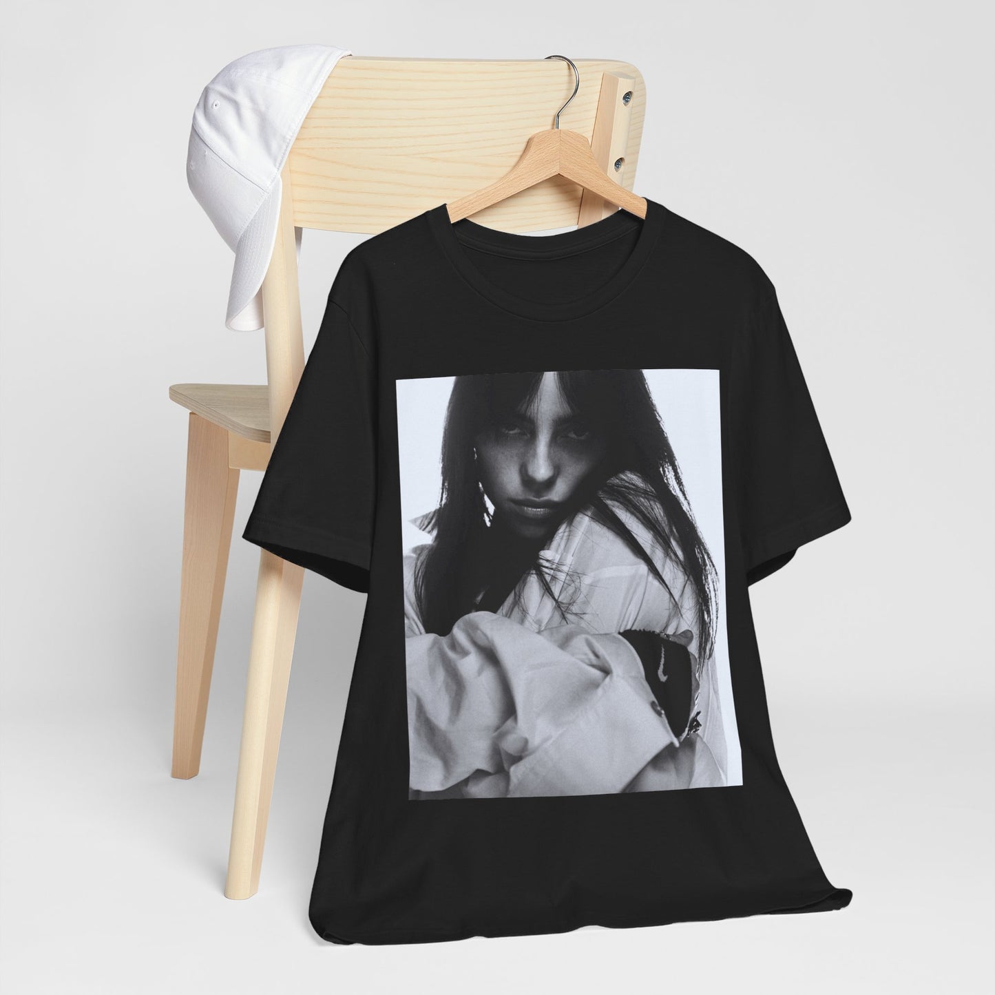 Billie Eilish posing in her signature oversized designer streetwear, printed on a graphic t-shirt.