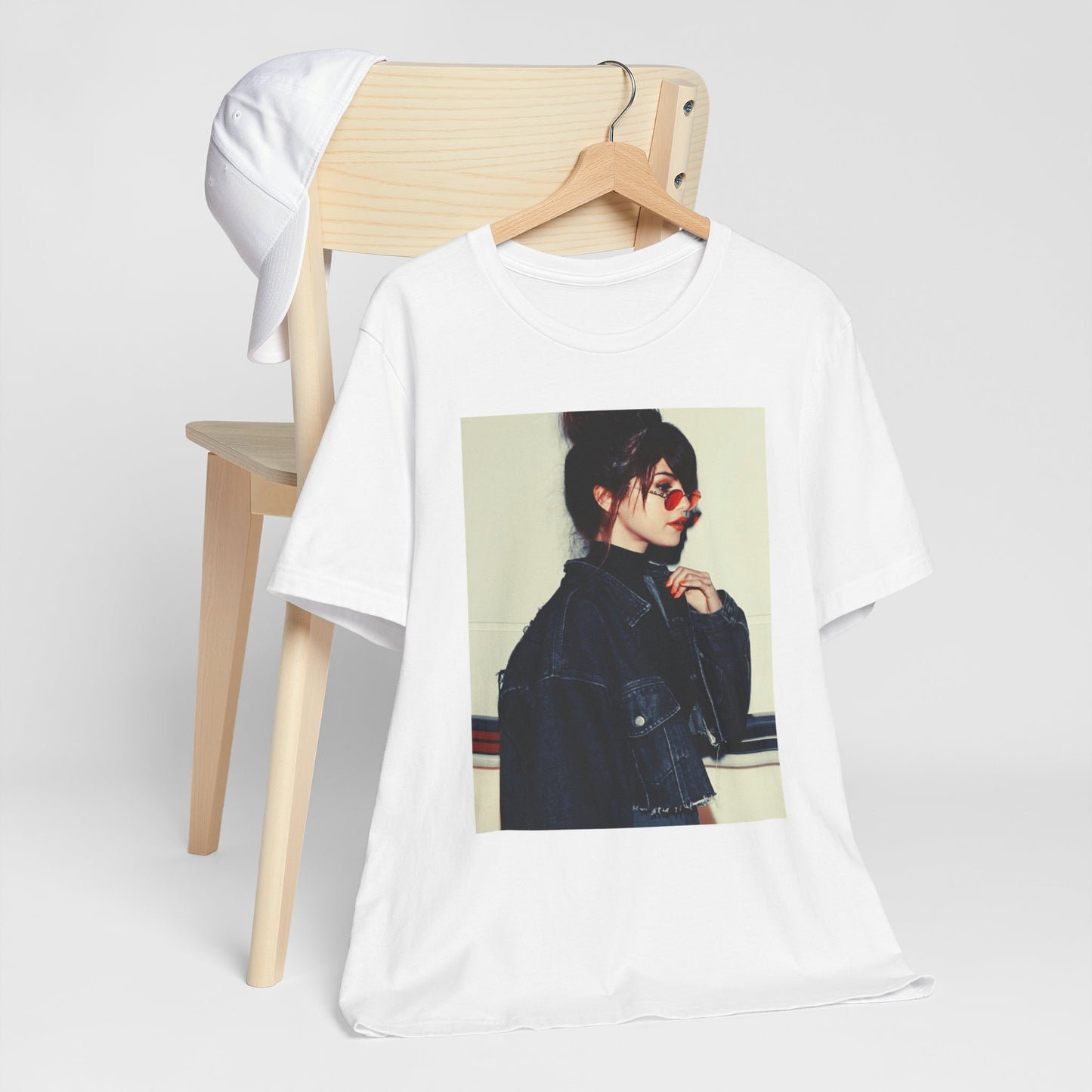 A black graphic t-shirt featuring a bold graphic of Selena Gomez as a pop superstar.