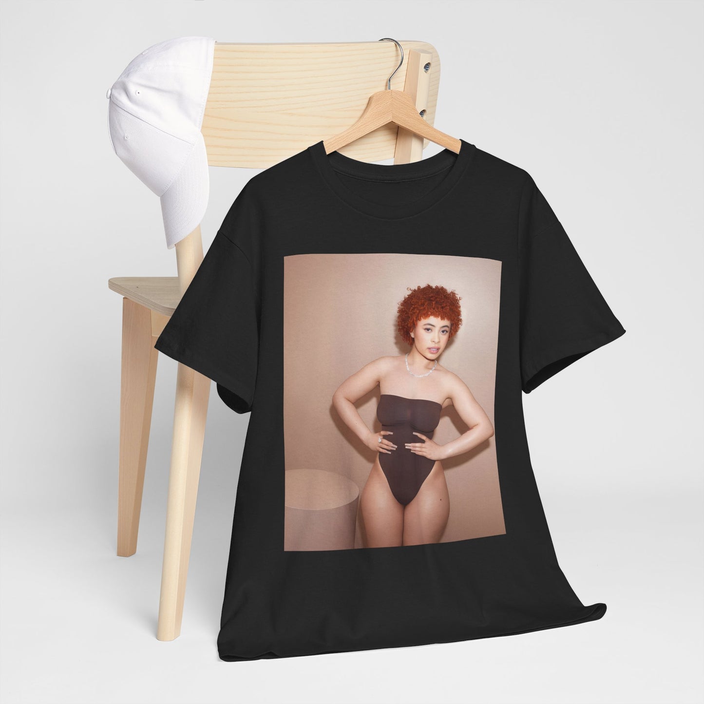 A black graphic t-shirt featuring a graphic of Ice Spice with her curly hair, emphasizing her iconic fashion status.