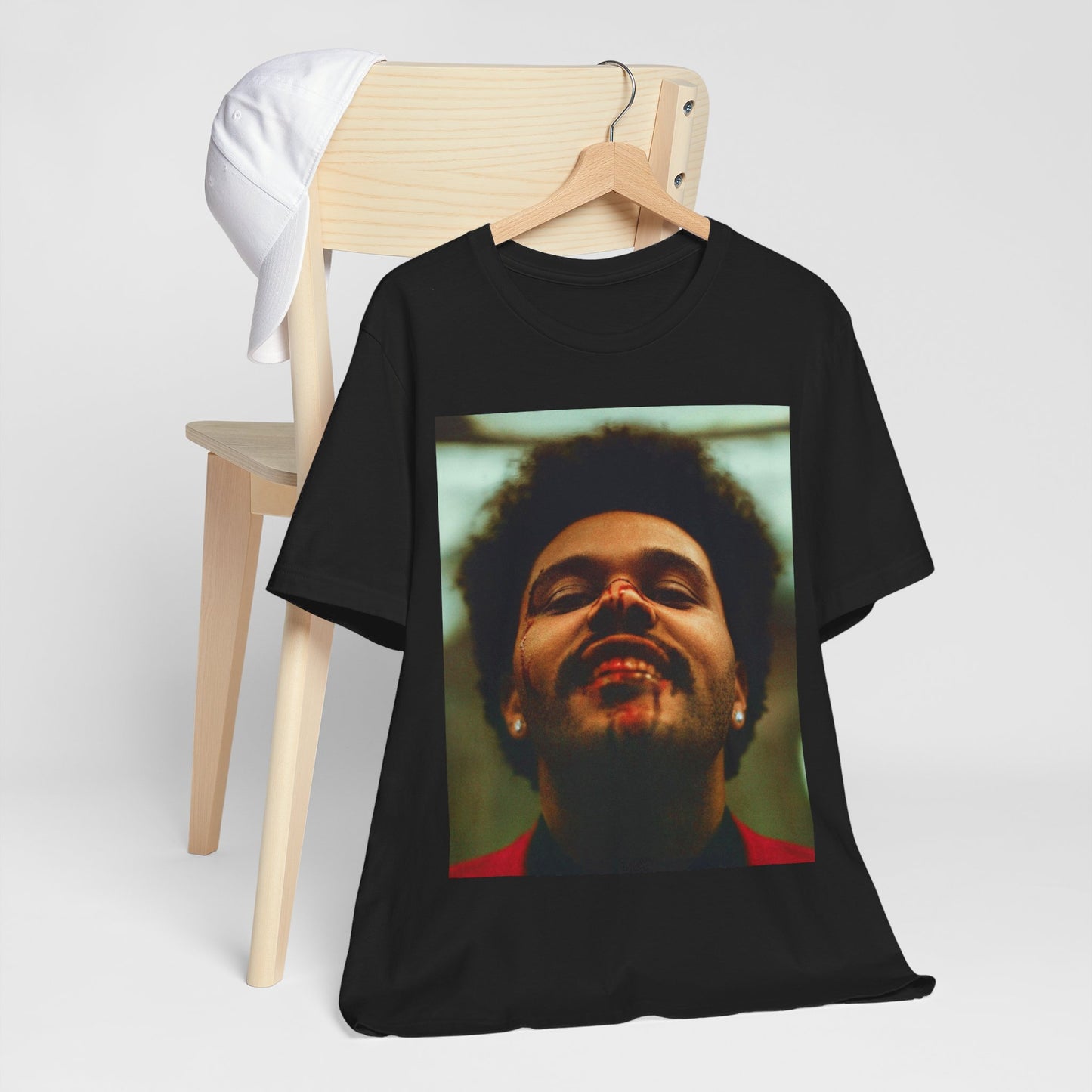 A black graphic t-shirt featuring the album cover art for The Weeknd's 'After Hours'.