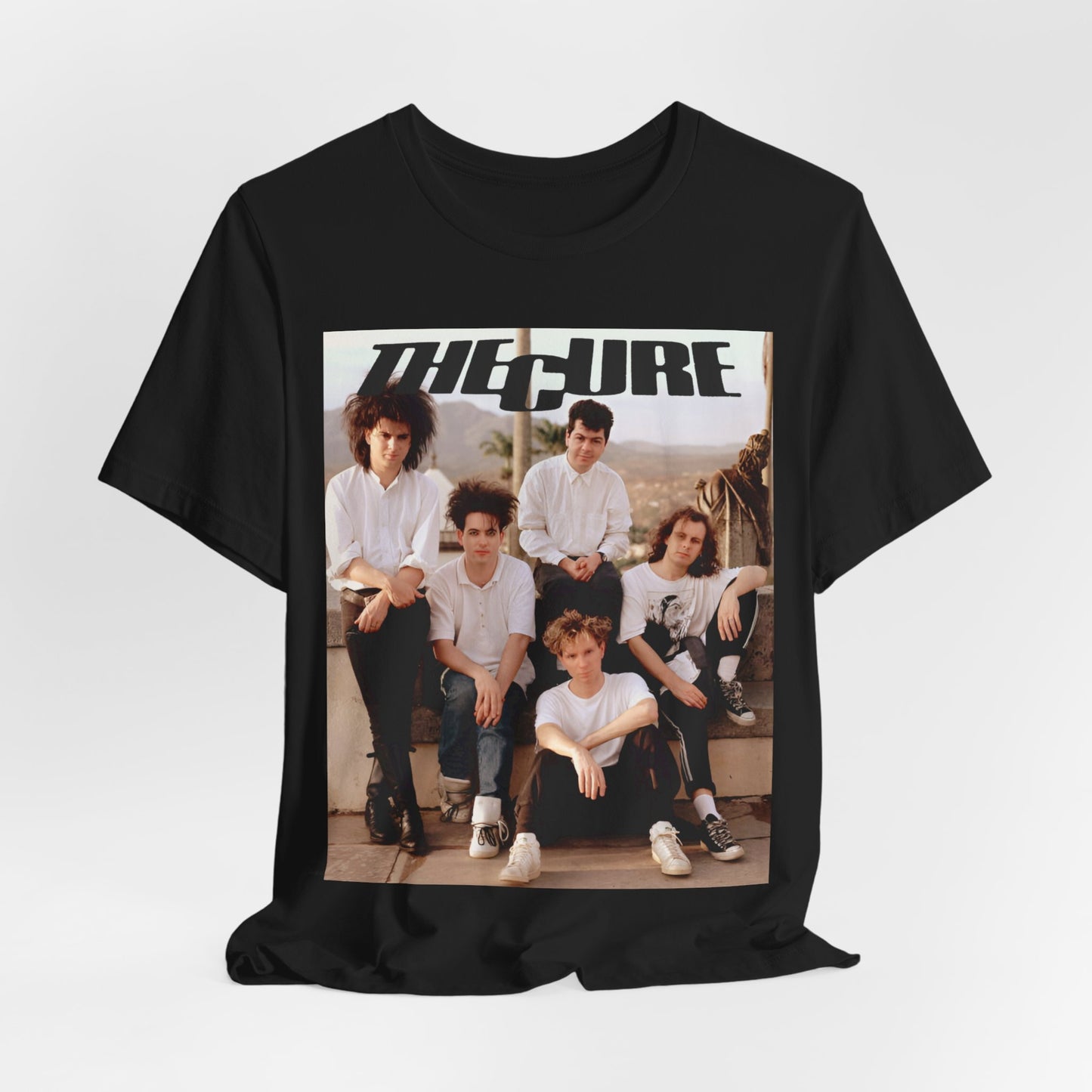 A black graphic t-shirt featuring a vintage graphic of The Cure with a dark romanticism theme.