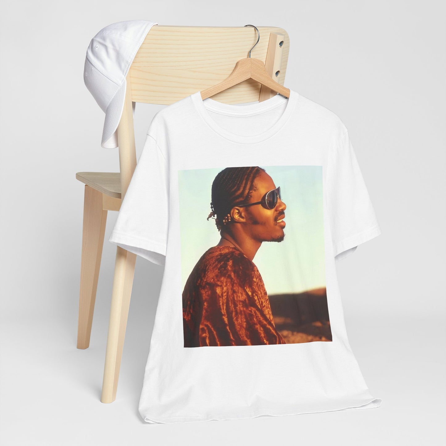 A black graphic t-shirt featuring a graphic of Stevie Wonder as an iconic style pop innovator.