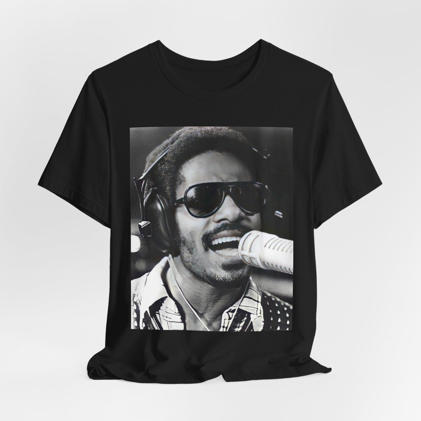 A black graphic t-shirt featuring a graphic of Stevie Wonder as a timeless visionary.
