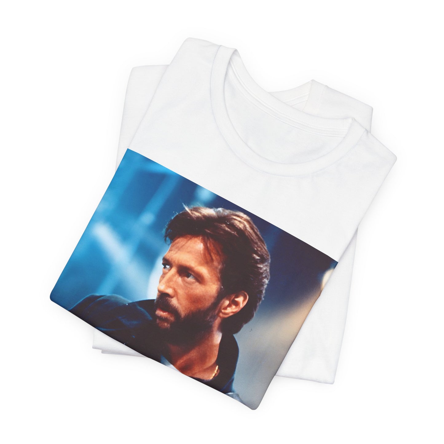 A black graphic t-shirt featuring a retro graphic or photo of Eric Clapton performing live on stage.