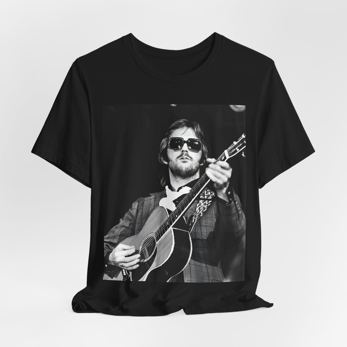 A black graphic t-shirt featuring a graphic of Eric Clapton with a chill blues rock vibe.