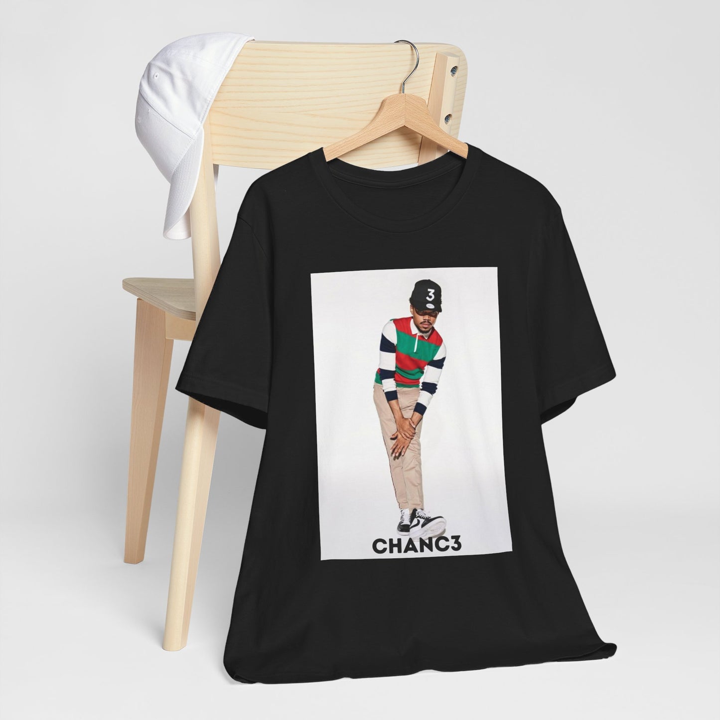 A black graphic t-shirt featuring a graphic of Chance the Rapper with a positive or 'feel good' hip hop vibe.