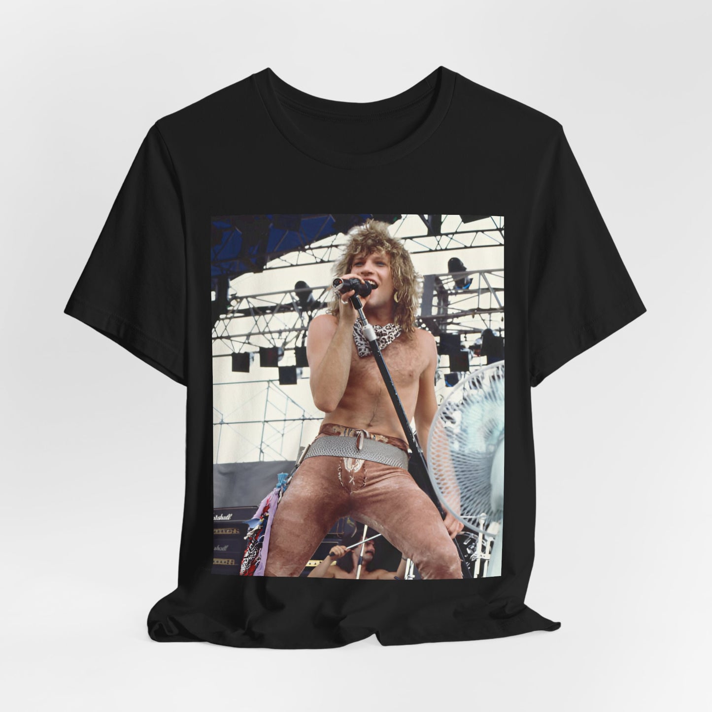 A black graphic t-shirt featuring a dynamic graphic or photo of Bon Jovi performing live on stage with a fierce intensity.