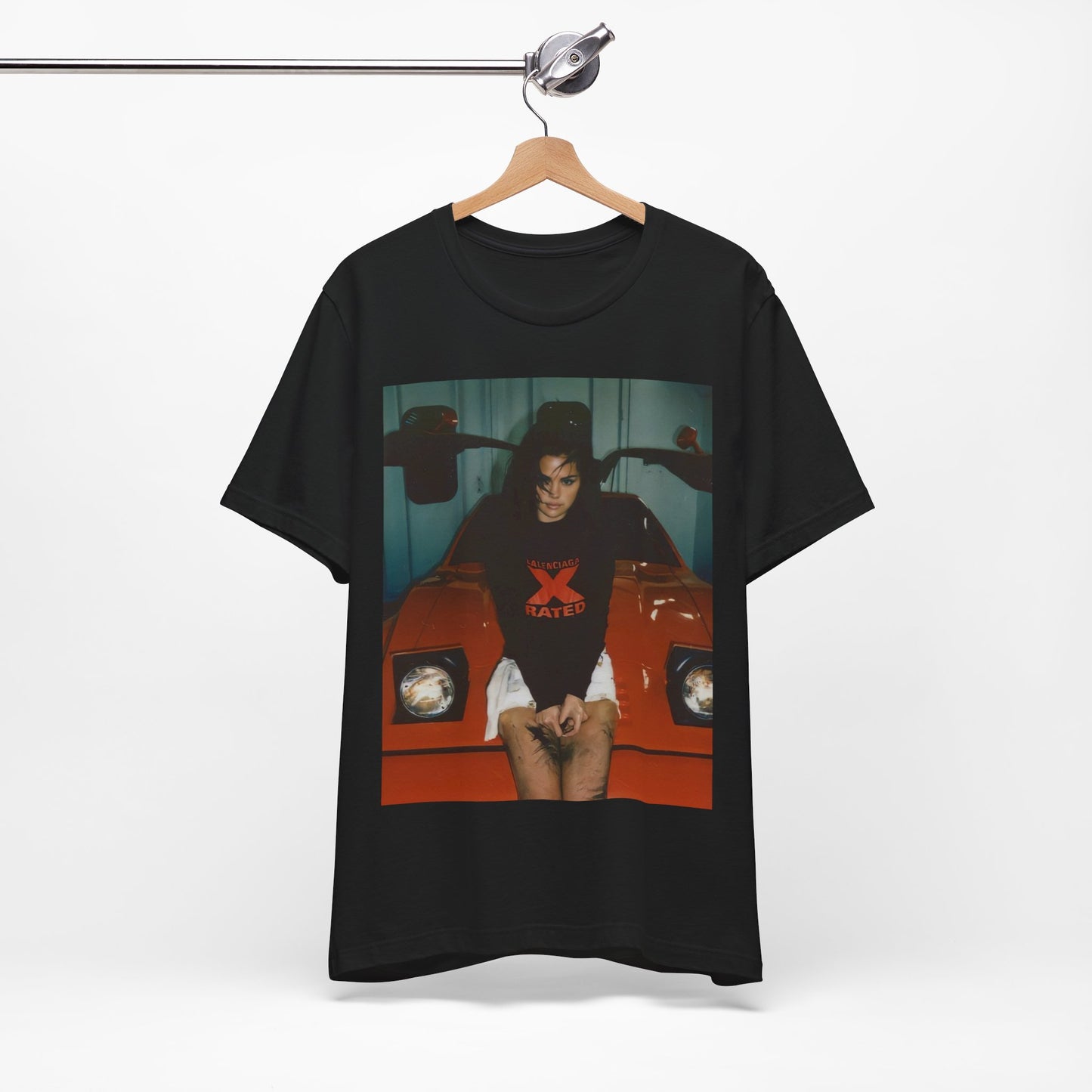 A black graphic t-shirt featuring a photo or graphic of Selena Gomez with a car, designed with an 'X Rated' or edgy aesthetic.
