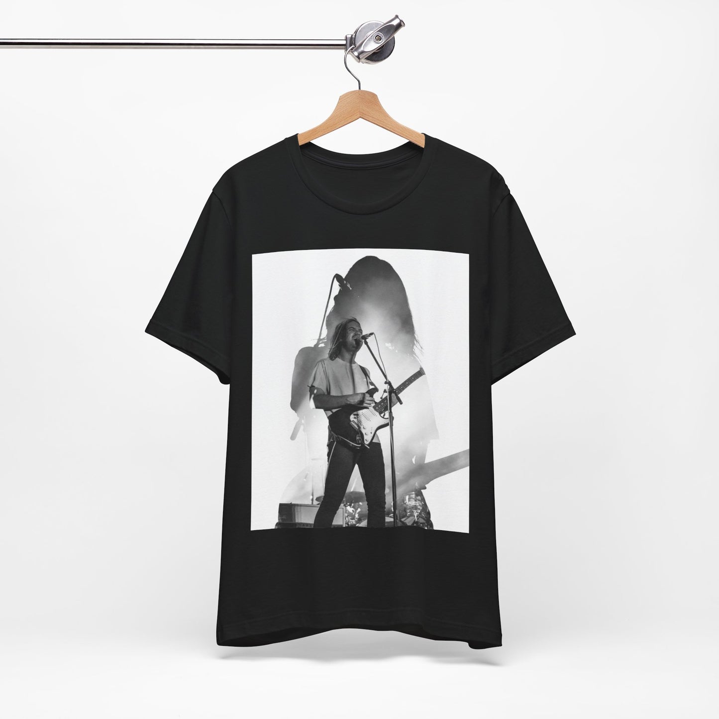 A black graphic t-shirt featuring a black and white, monochrome graphic or photo of Tame Impala.