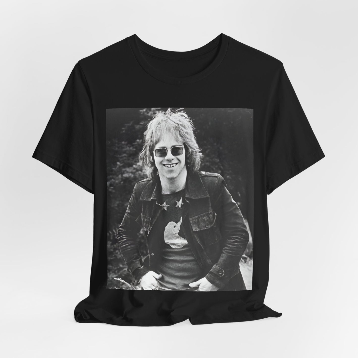 A black graphic t-shirt featuring a 70s black and white monochrome graphic or photo of Elton John.