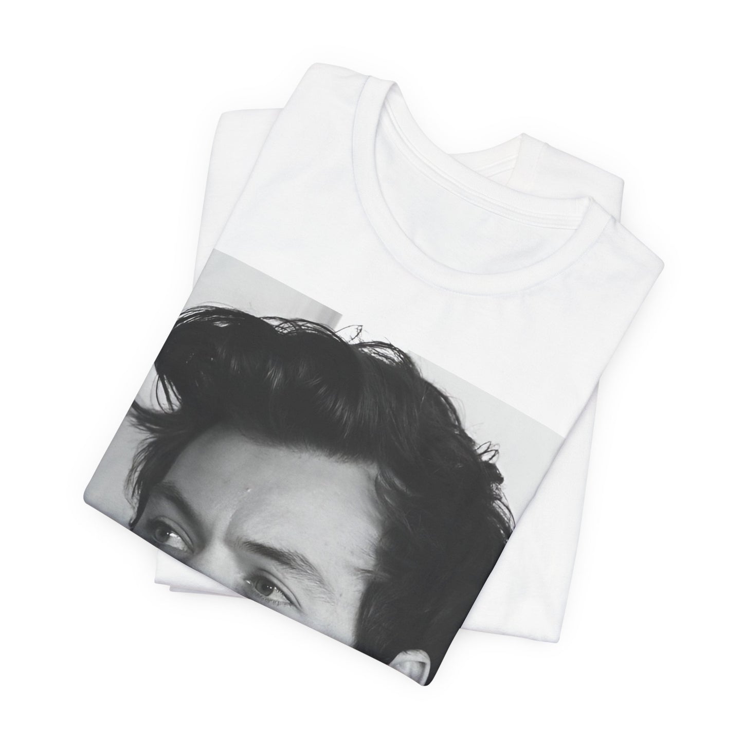 A black graphic t-shirt featuring a black and white, monochrome graphic or photo of Harry Styles.