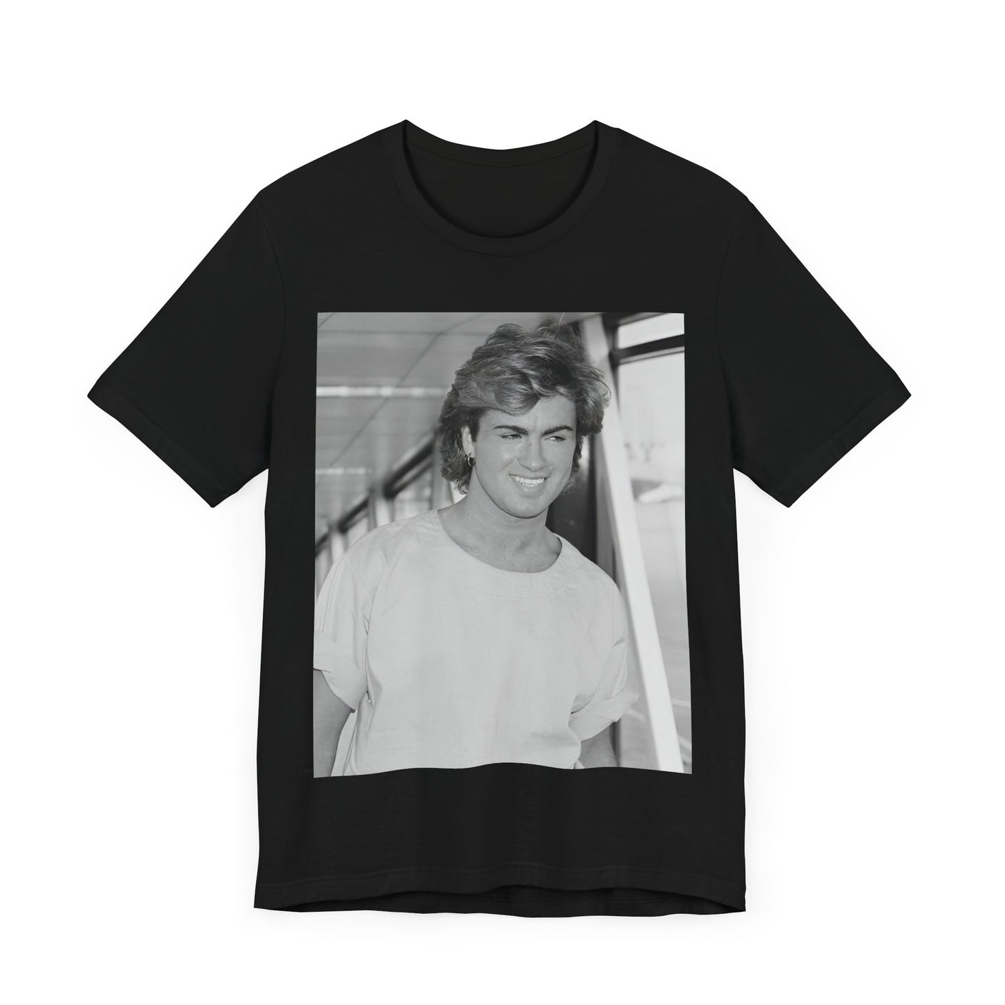 A black graphic t-shirt featuring an 80s black and white vintage photo or graphic of George Michael.