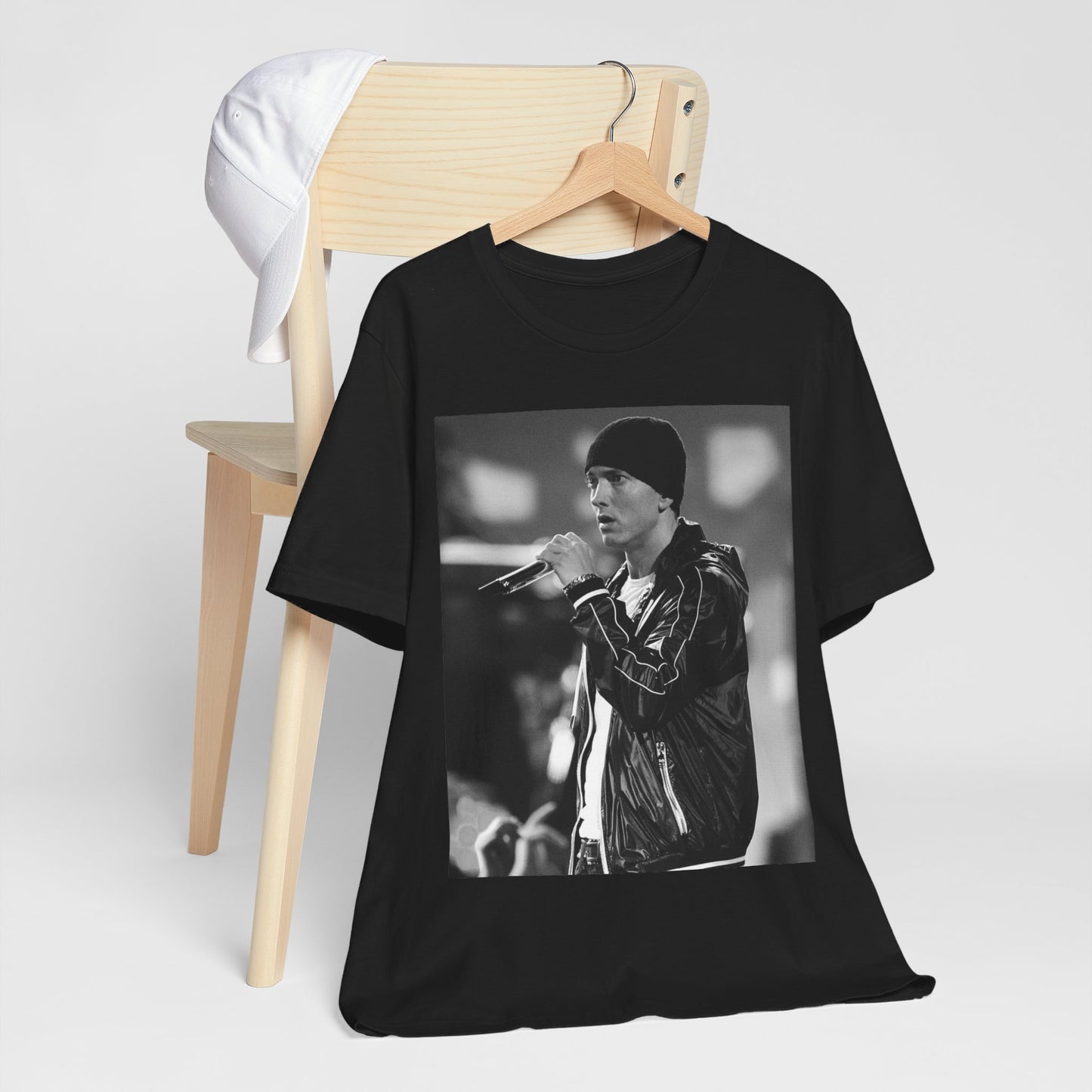 A black graphic t-shirt featuring a classic 90s graphic of Eminem as a 'Rap God'.