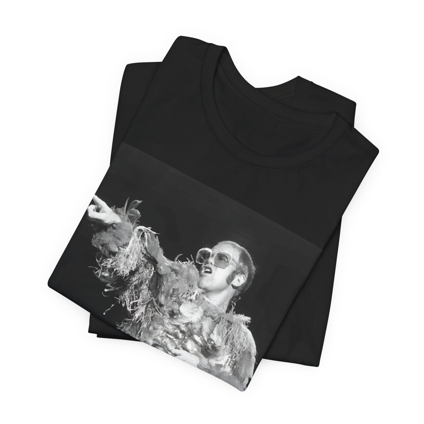 A black graphic t-shirt featuring a retro graphic of Elton John as a rock legend performing live.