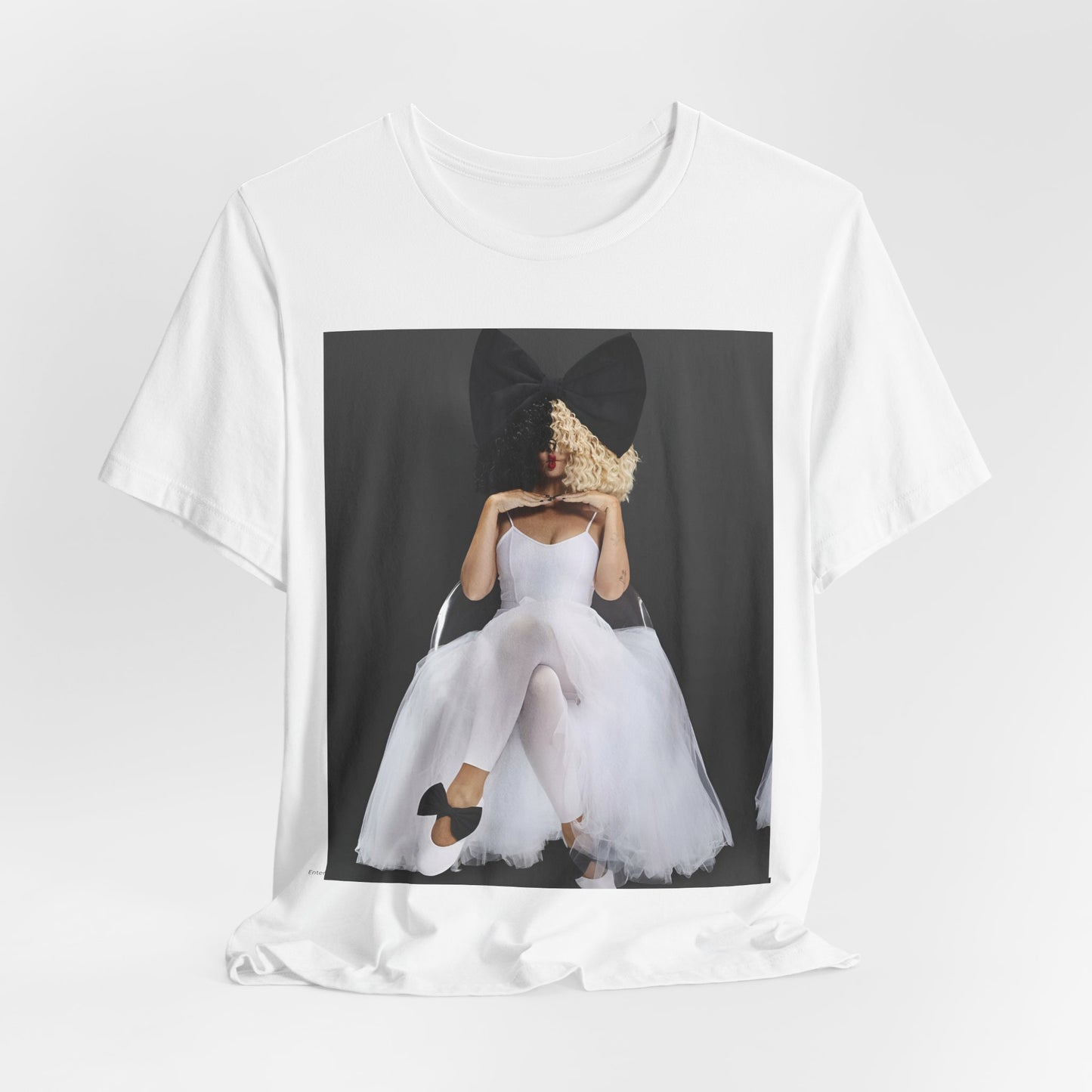 A black graphic t-shirt featuring a graphic of Sia's iconic wig style.