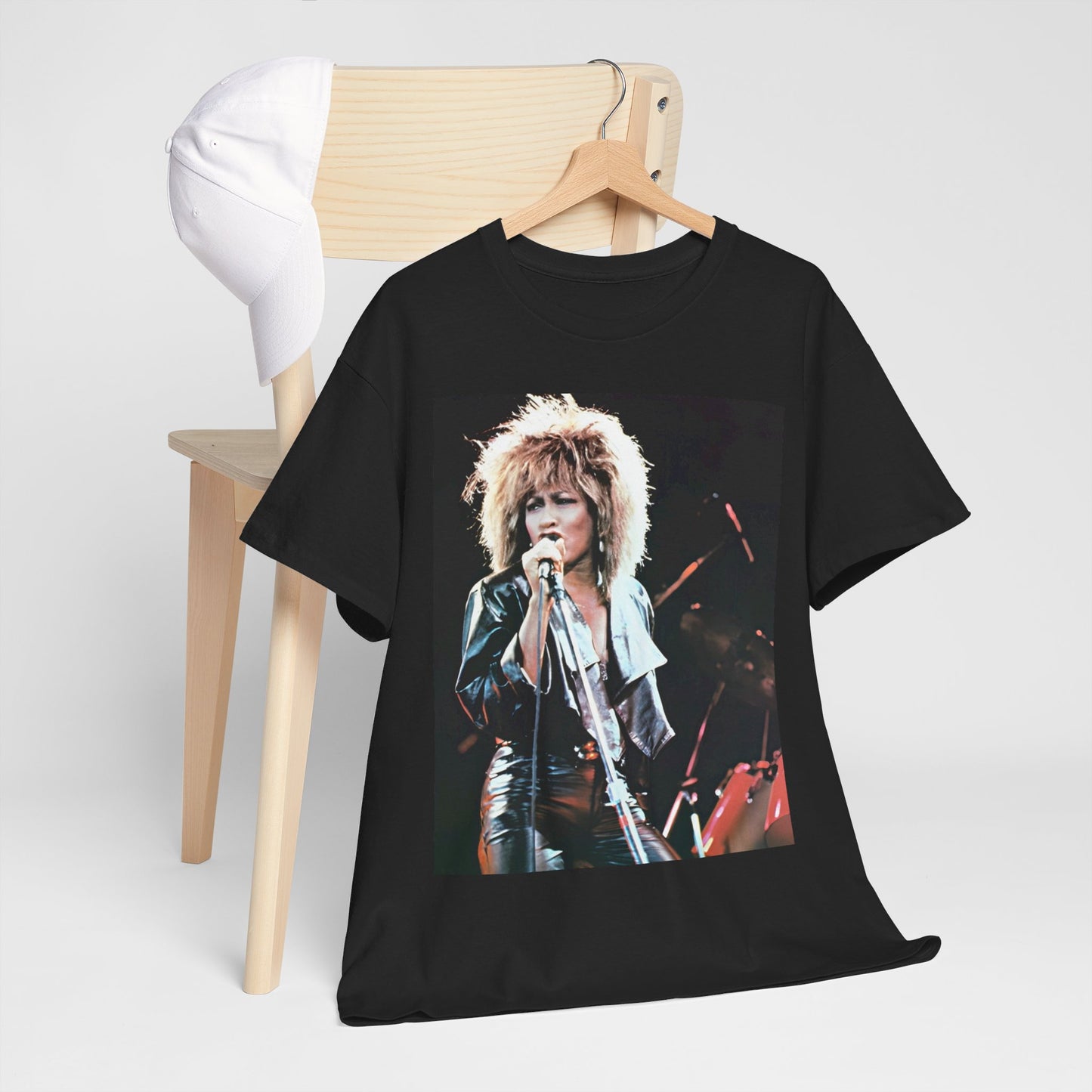 A black graphic t-shirt featuring a 90s graphic or photo of Tina Turner performing live on stage.