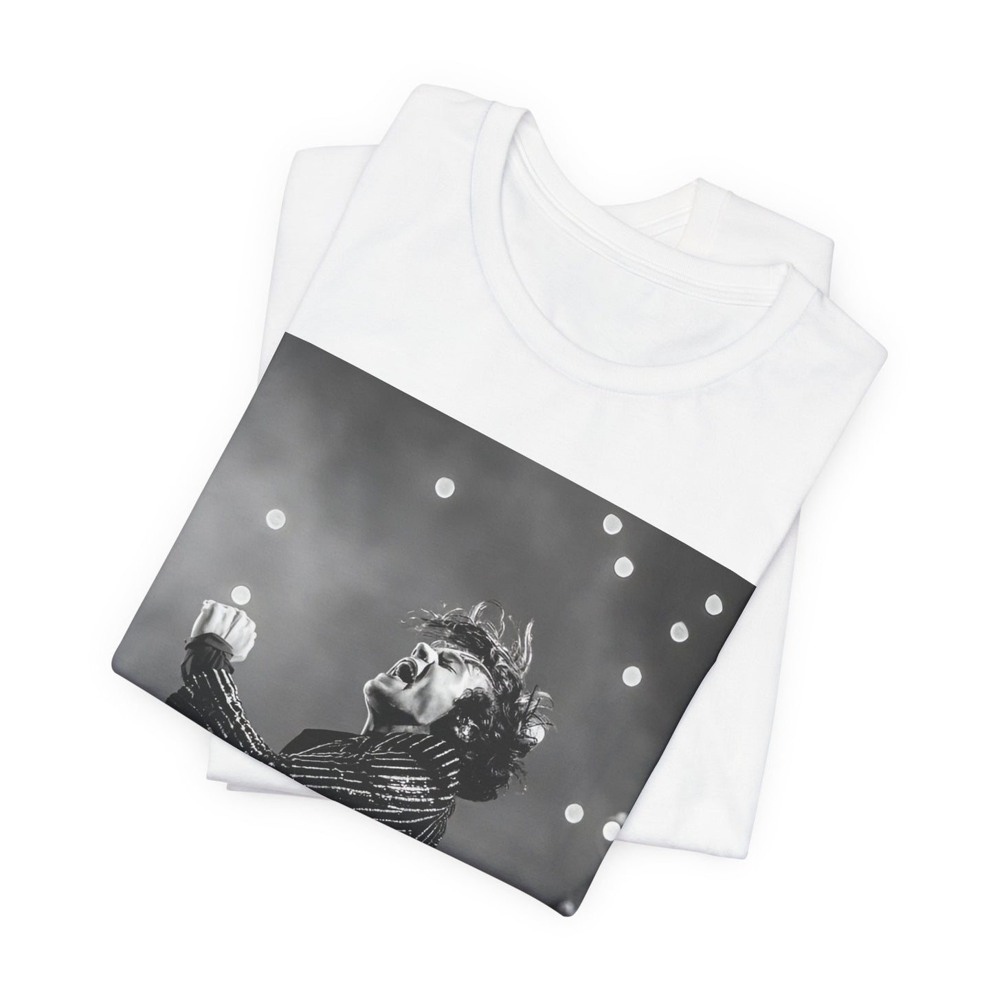 A black graphic t-shirt featuring a glamorous graphic or photo of Harry Styles performing on stage.