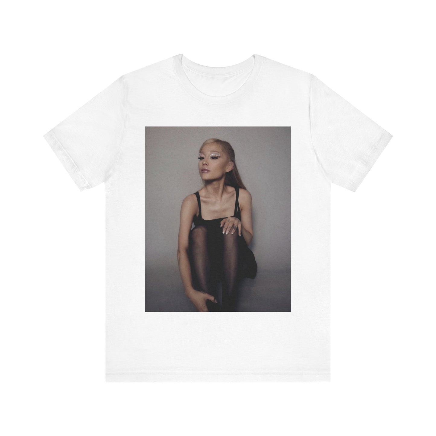 A black graphic t-shirt featuring a bold and beautiful graphic of Ariana Grande, emphasizing her strong and confident presence.