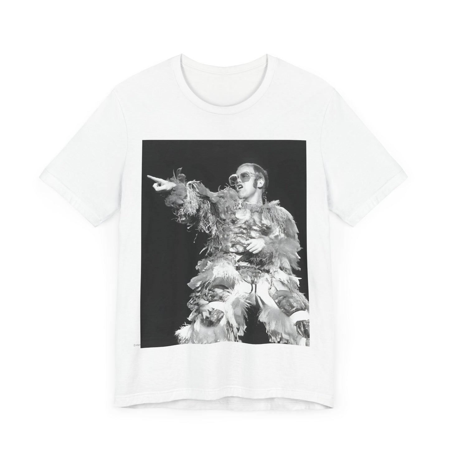 A black graphic t-shirt featuring a retro graphic of Elton John as a rock legend performing live.