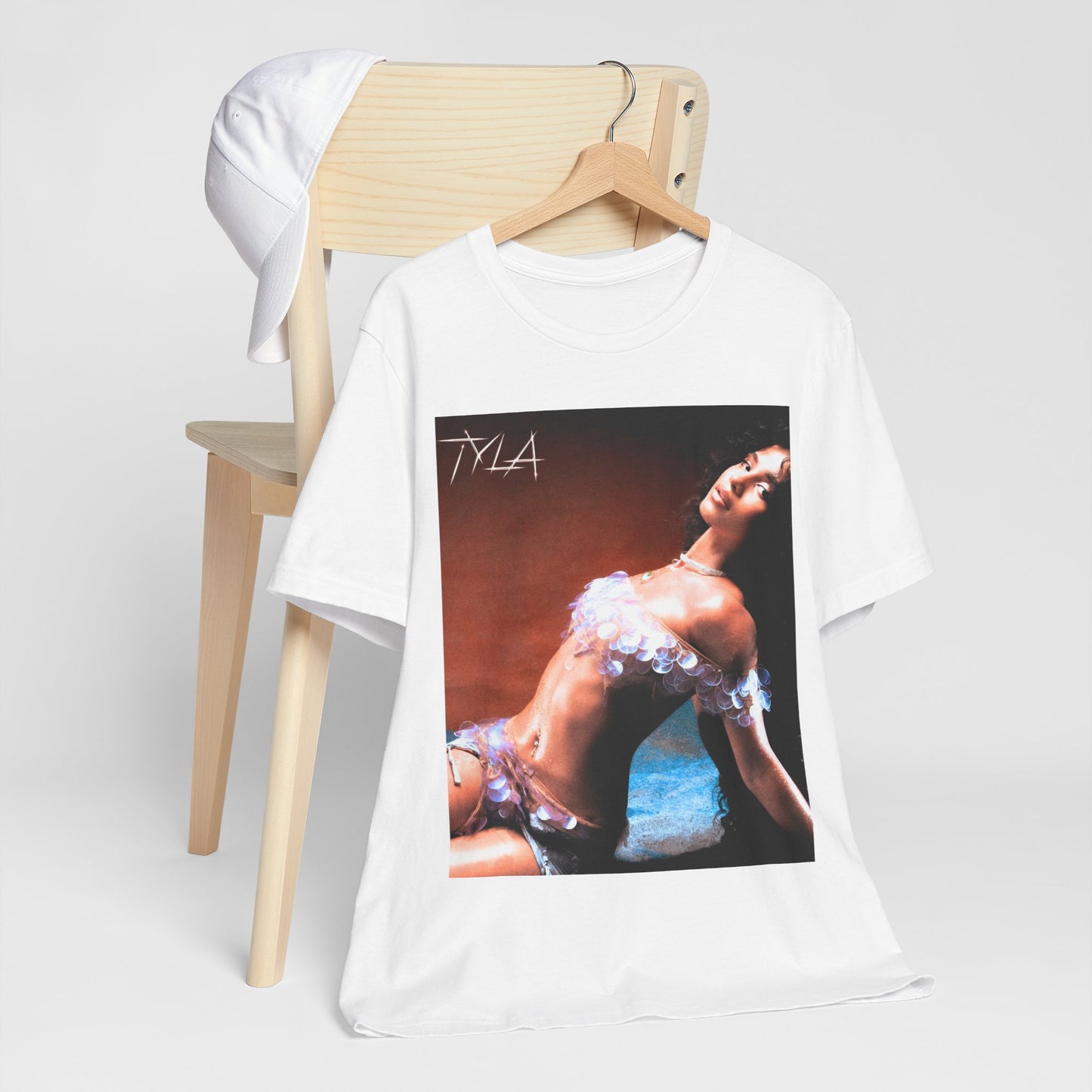 A black graphic t-shirt featuring a cultural fusion vibes graphic of Tyla.