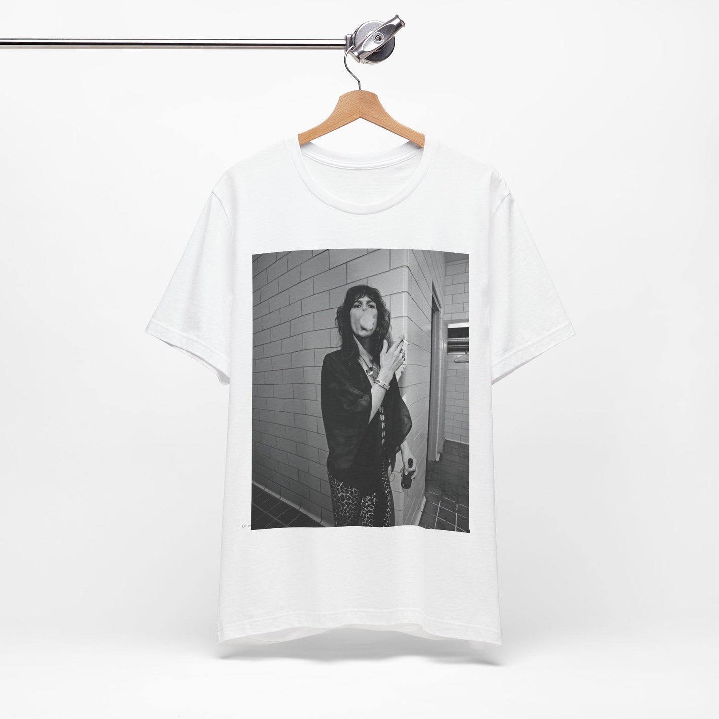 A black graphic t-shirt featuring a retro 70s photo of Aerosmith band members in a backstage setting, showing a candid moment.