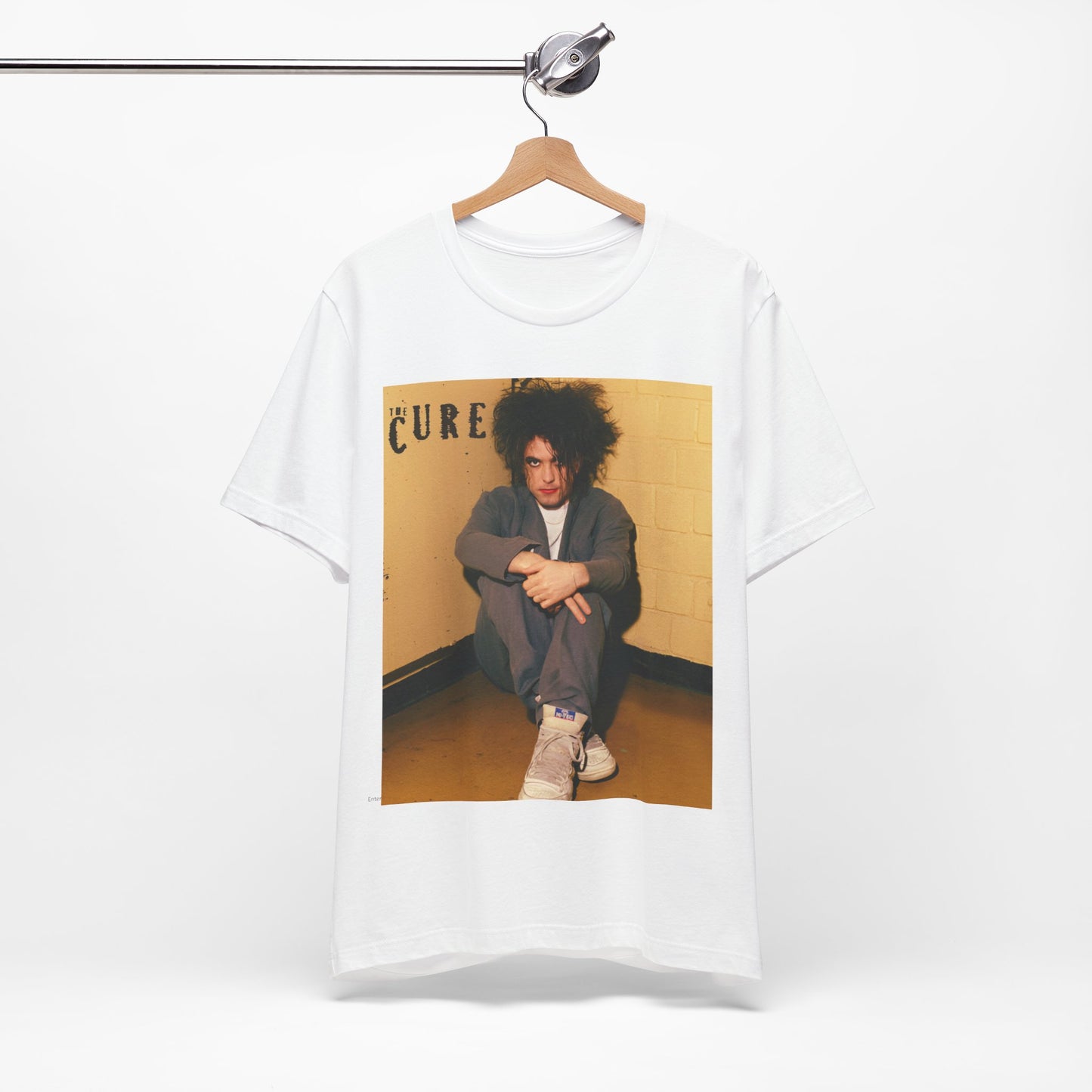 A black graphic t-shirt featuring a bold goth rock superstar graphic of The Cure.