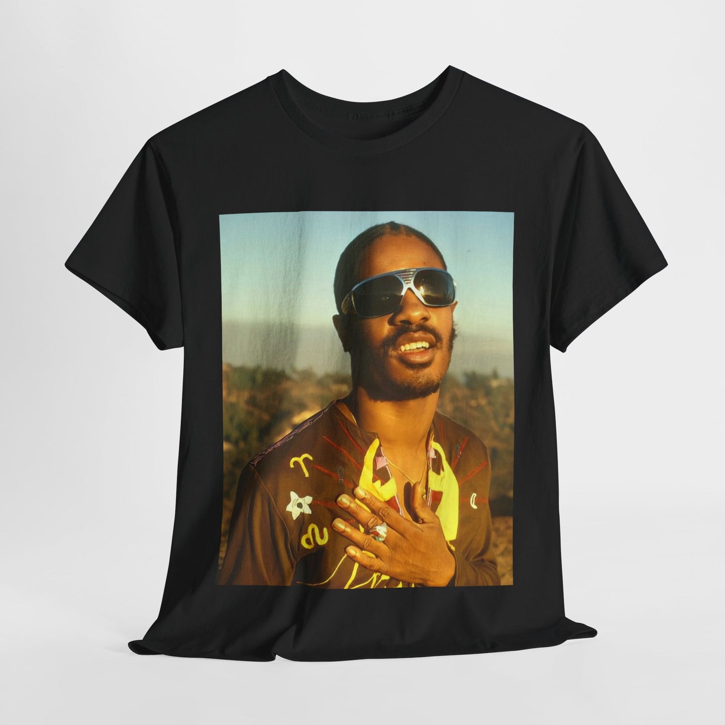 A black graphic t-shirt featuring a 70s cool musical genius graphic of Stevie Wonder.