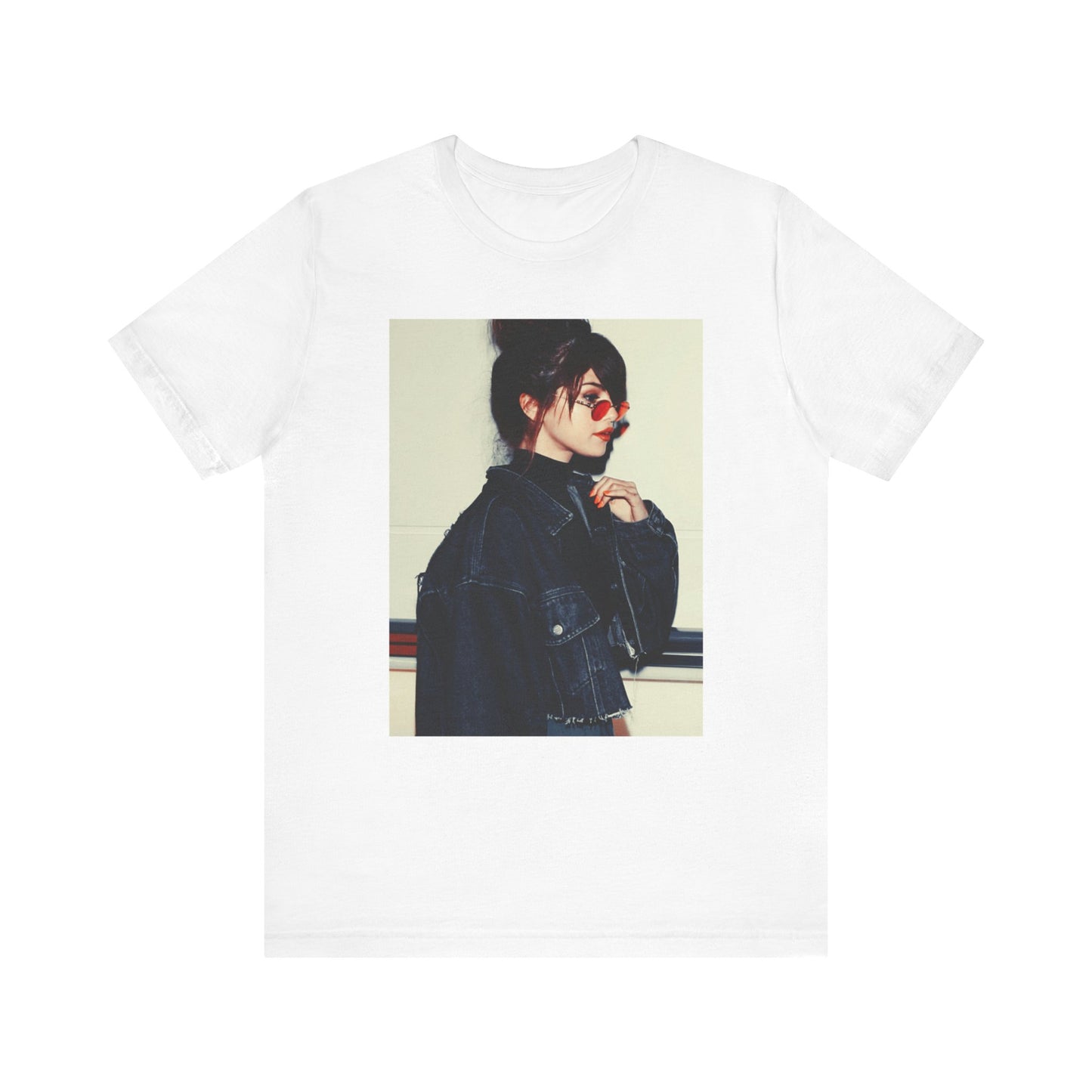 A black graphic t-shirt featuring a bold graphic of Selena Gomez as a pop superstar.
