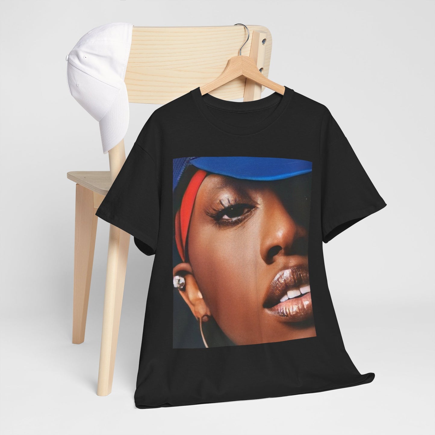 A black graphic t-shirt featuring a graphic of Missy Elliott as a creative genius in hip hop.