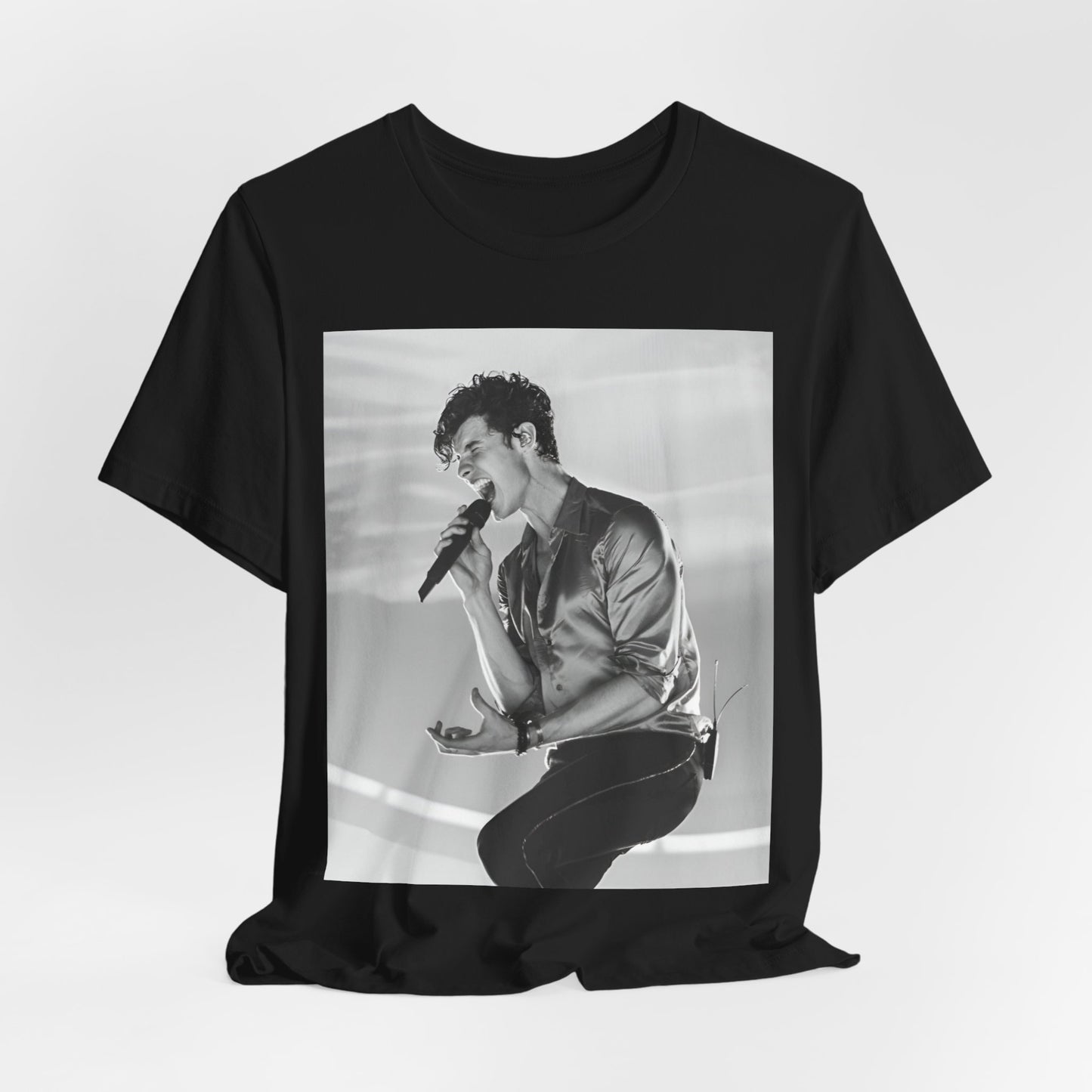 A black graphic t-shirt featuring a black and white graphic or photo of Shawn Mendes as a dreamy pop star.