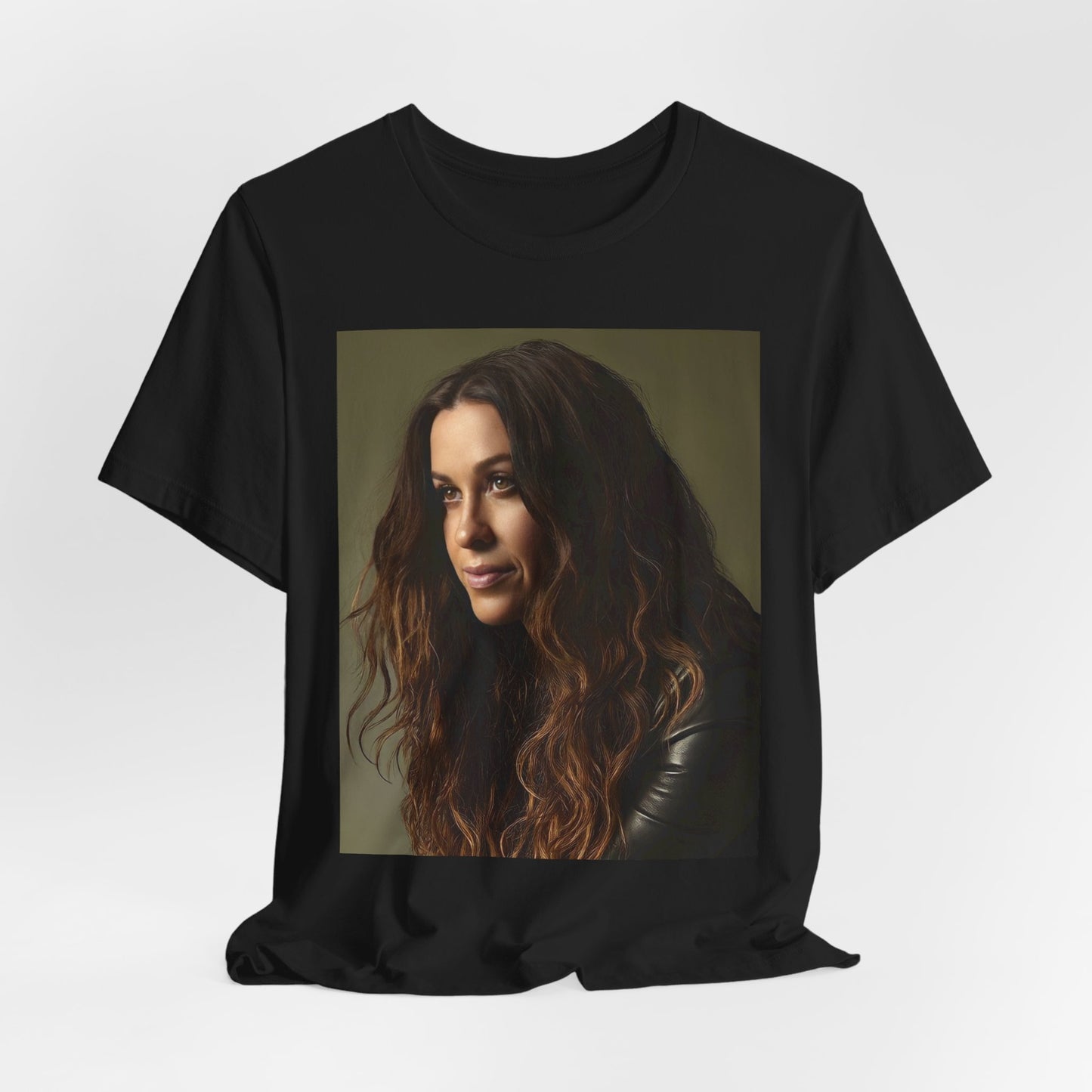 A black graphic t-shirt featuring a close-up portrait photo of Alanis Morissette, showing her intense or contemplative expression.