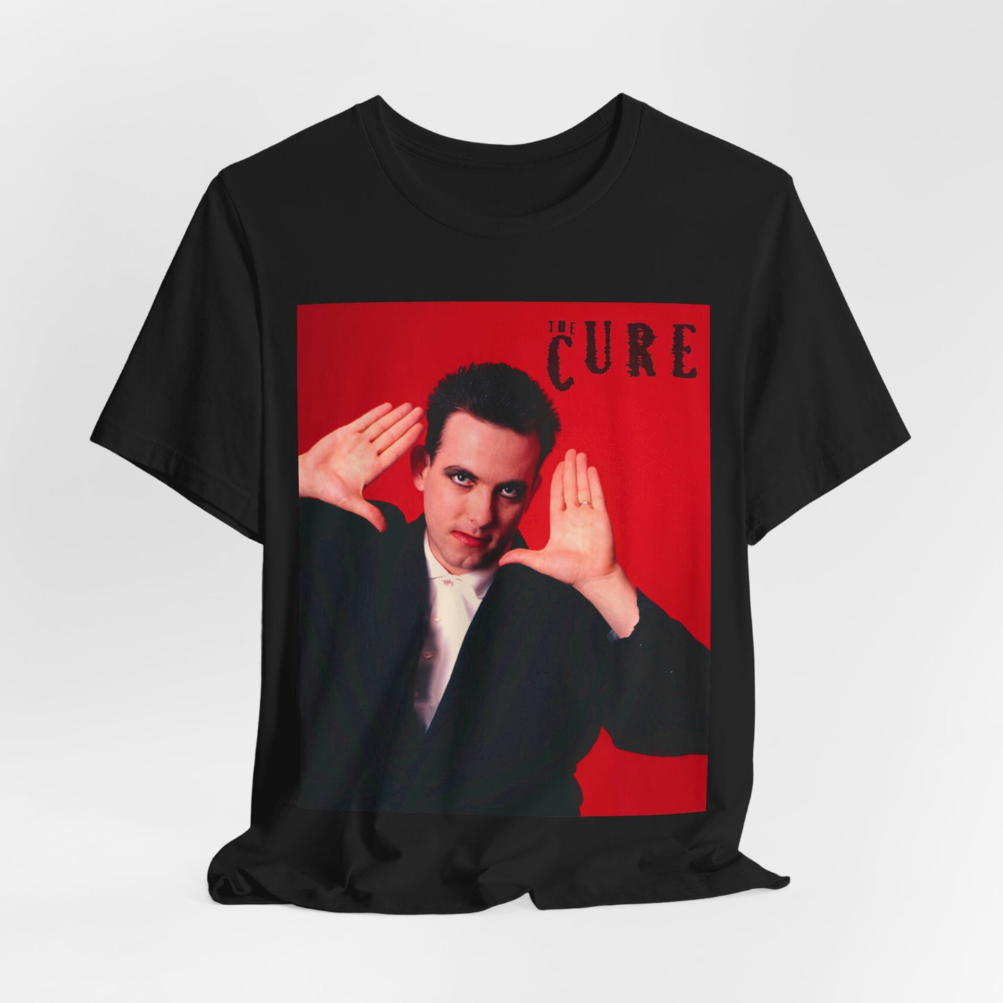 A black graphic t-shirt featuring a graphic of Robert Smith from The Cure in his authentic style.