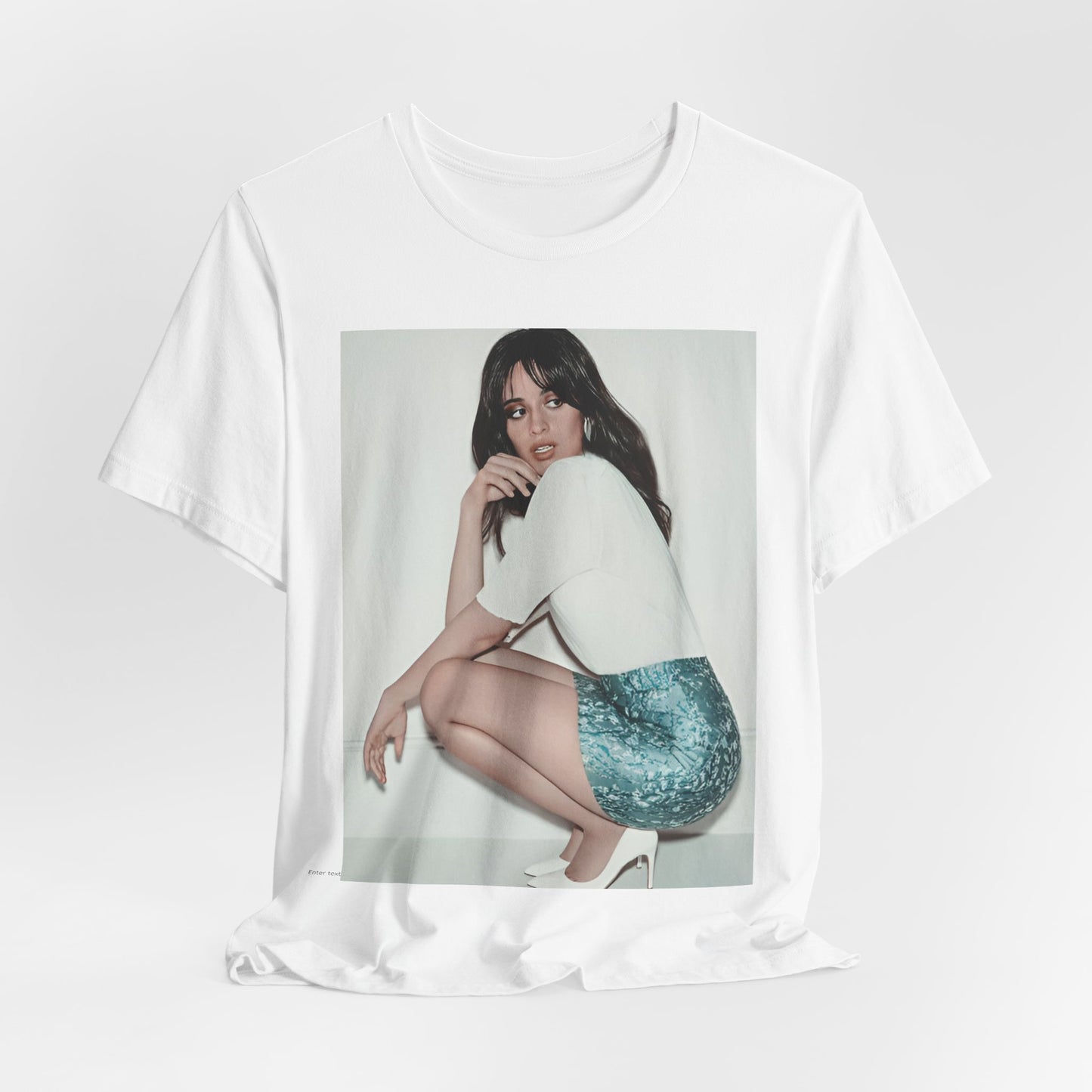 A black graphic t-shirt featuring a stylized graphic of Camila Cabello as a Latin pop princess.