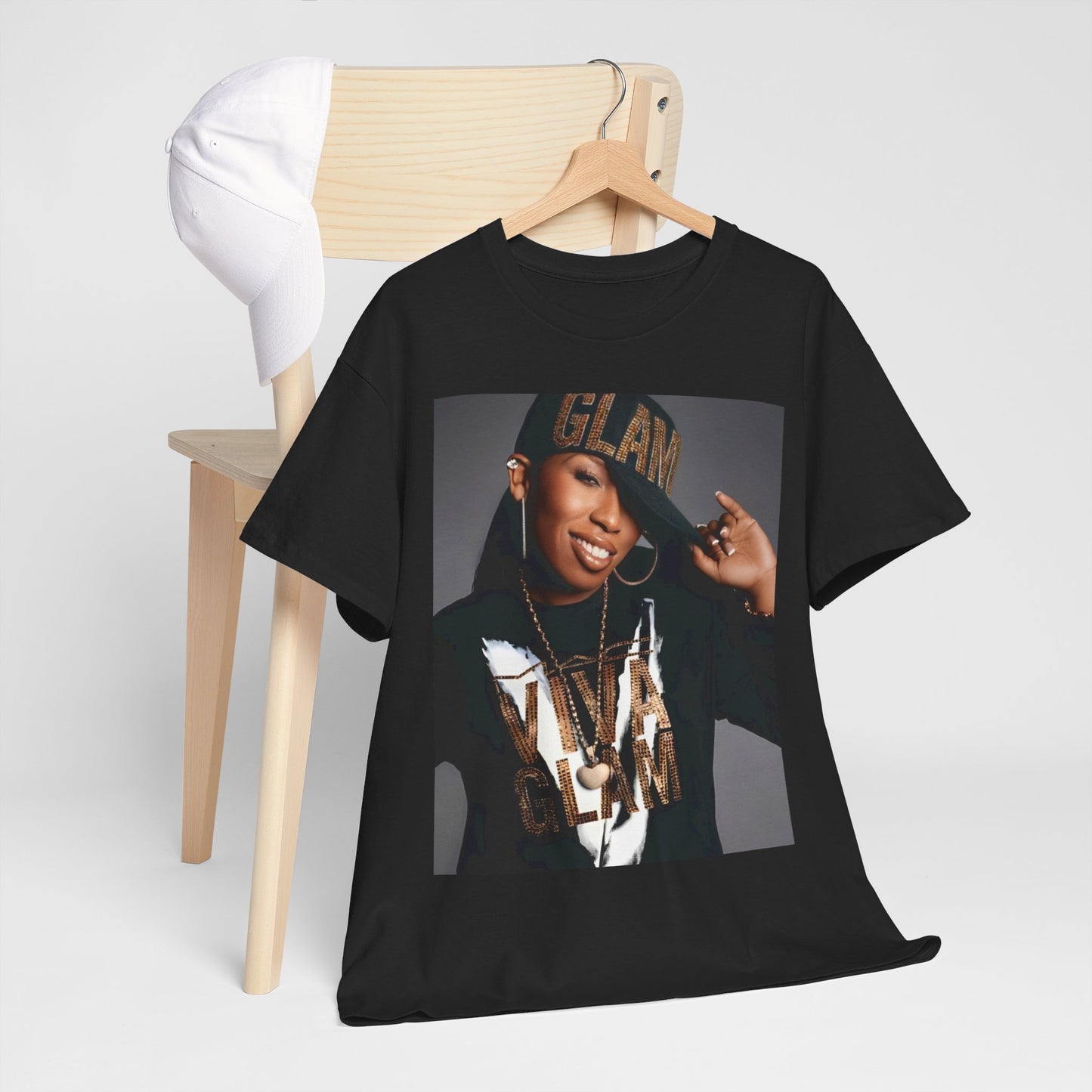 A black graphic t-shirt featuring a 90s graphic of Missy Elliott as a global rap phenomenon.