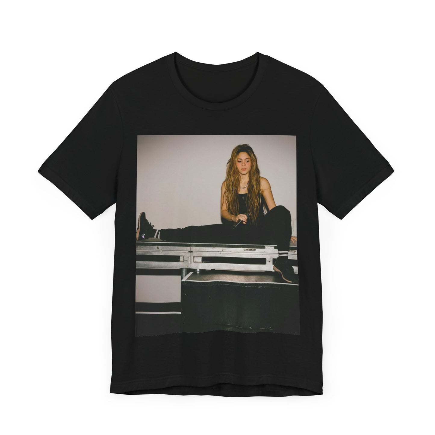 A black graphic t-shirt featuring a modern pop essential graphic of Shakira.