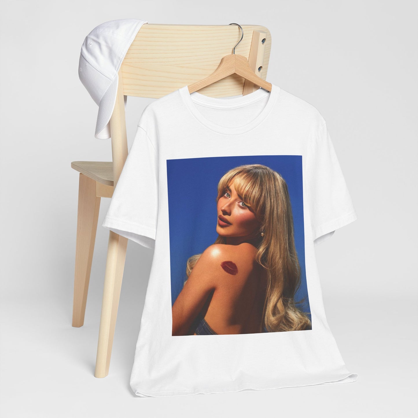 A black graphic t-shirt featuring a stylized graphic of Sabrina Carpenter, designed with a modern pop aesthetic.