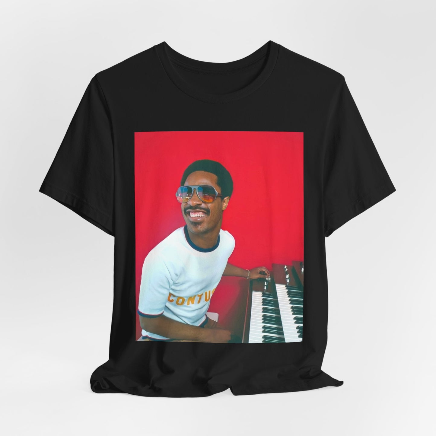 A black graphic t-shirt featuring a graphic of Stevie Wonder with a piano.