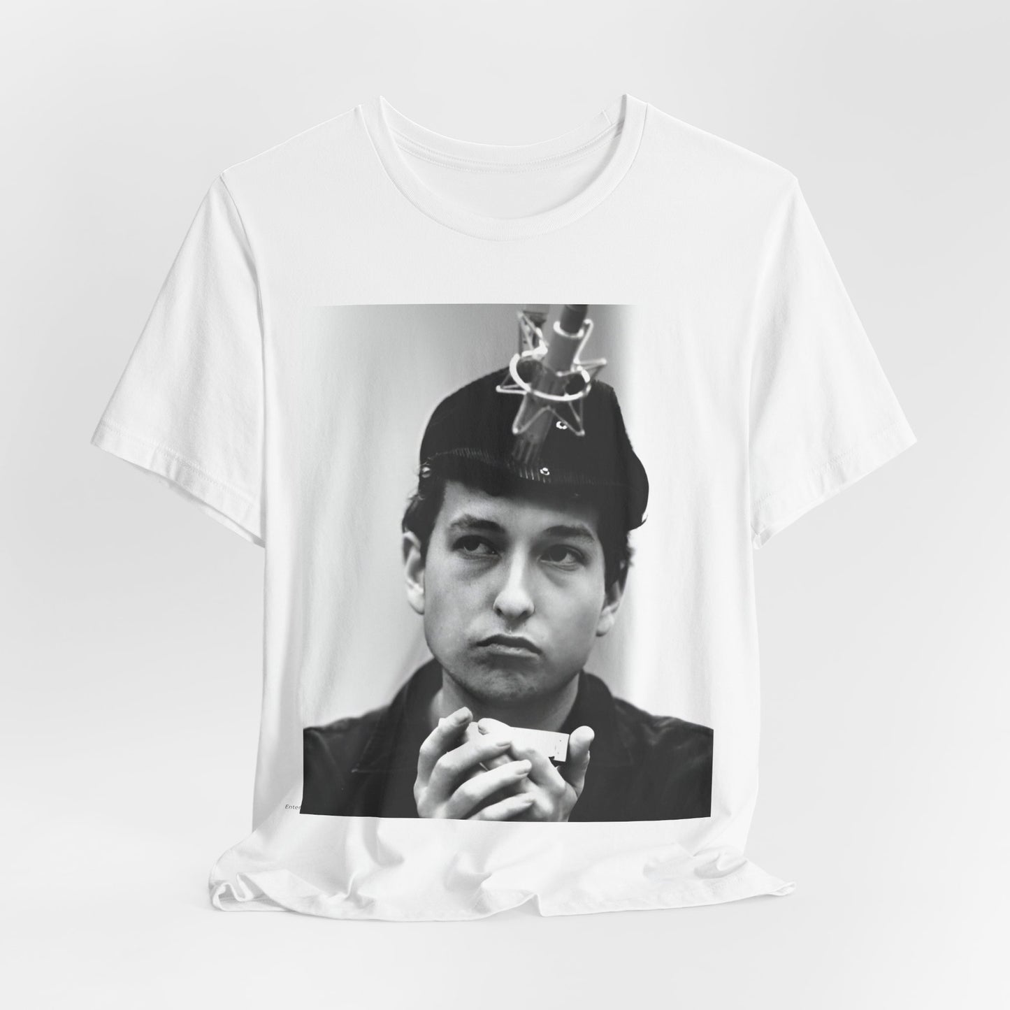 A black graphic t-shirt featuring a graphic of Bob Dylan in an acoustic session setting, possibly with his guitar.