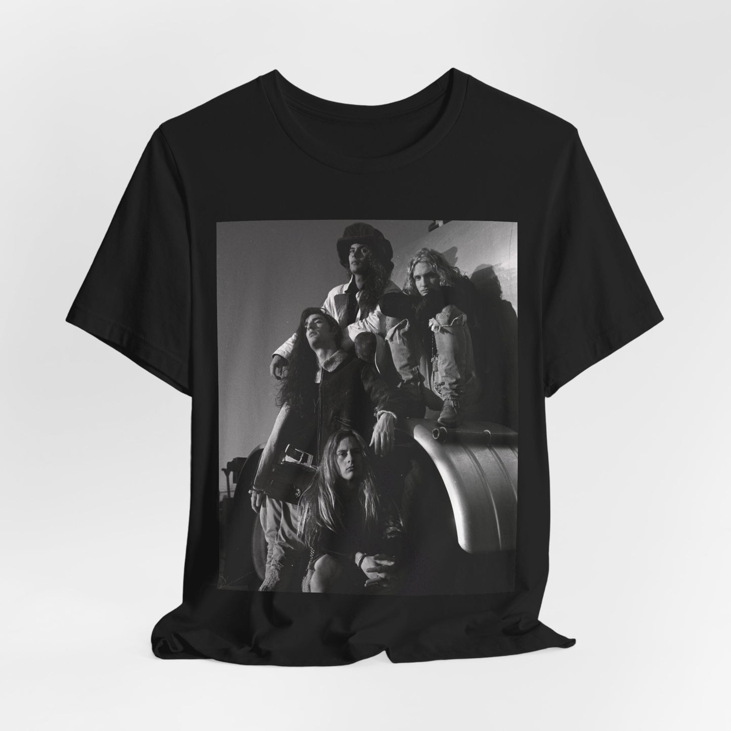 A black graphic t-shirt featuring a 90s black and white photographic portrait of the band Alice In Chains, capturing their iconic grunge look.