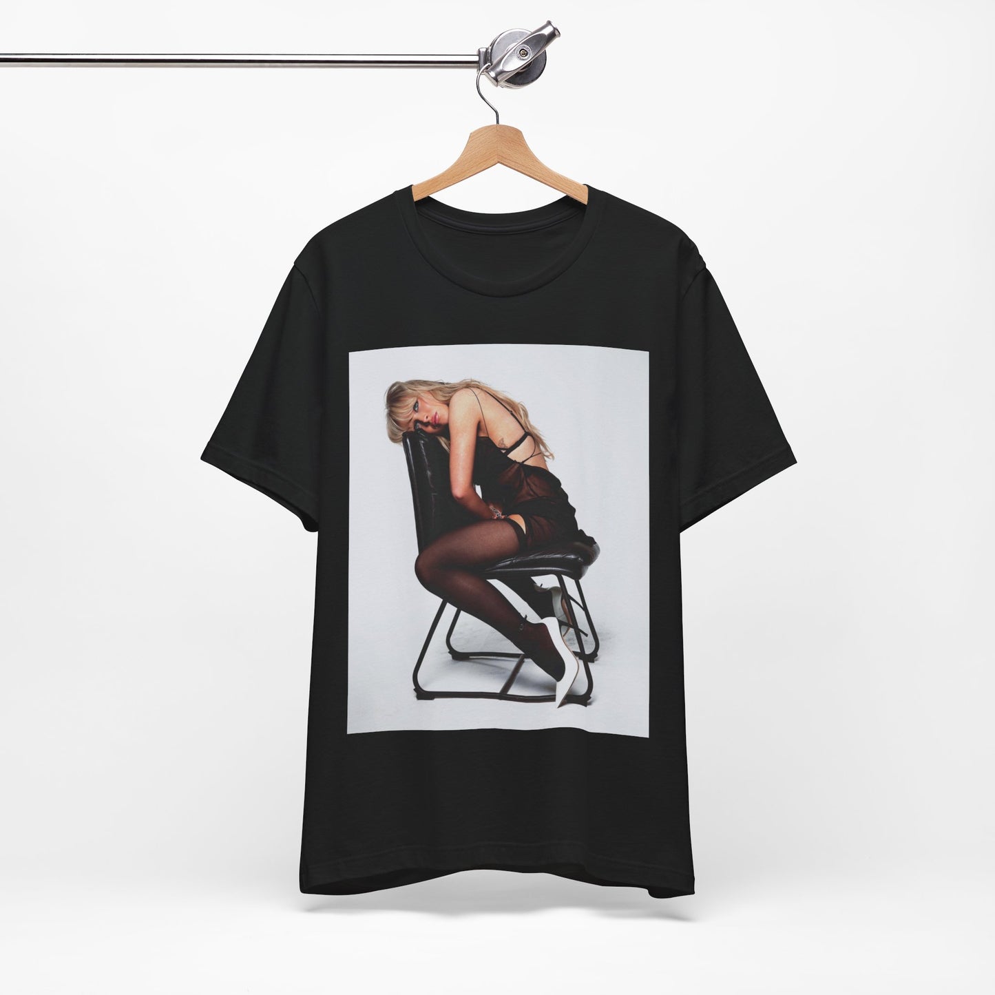 A black graphic t-shirt featuring a playful pop art style graphic of Sabrina Carpenter.