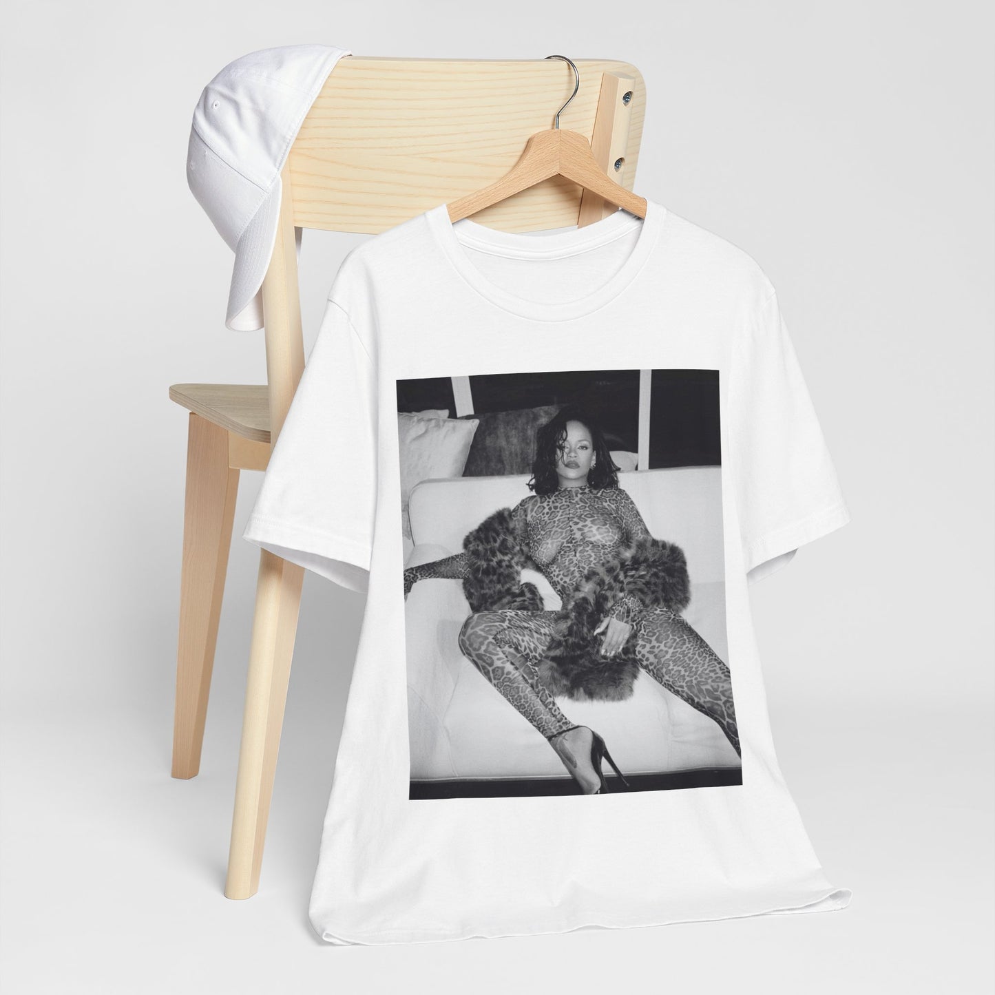 A black graphic t-shirt featuring a black and white, monochrome graphic or photo of Rihanna in a sexy pose.