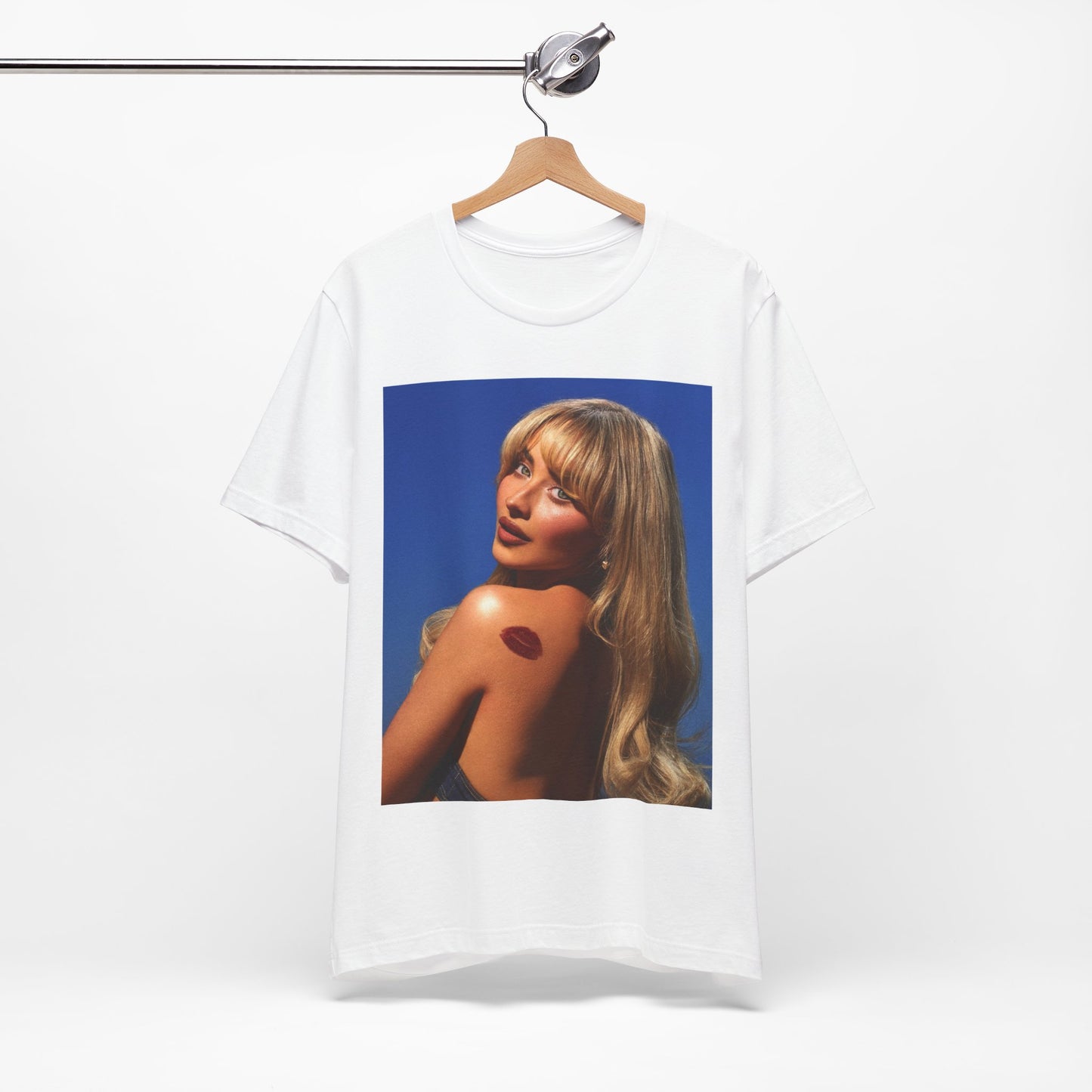 A black graphic t-shirt featuring a stylized graphic of Sabrina Carpenter, designed with a modern pop aesthetic.