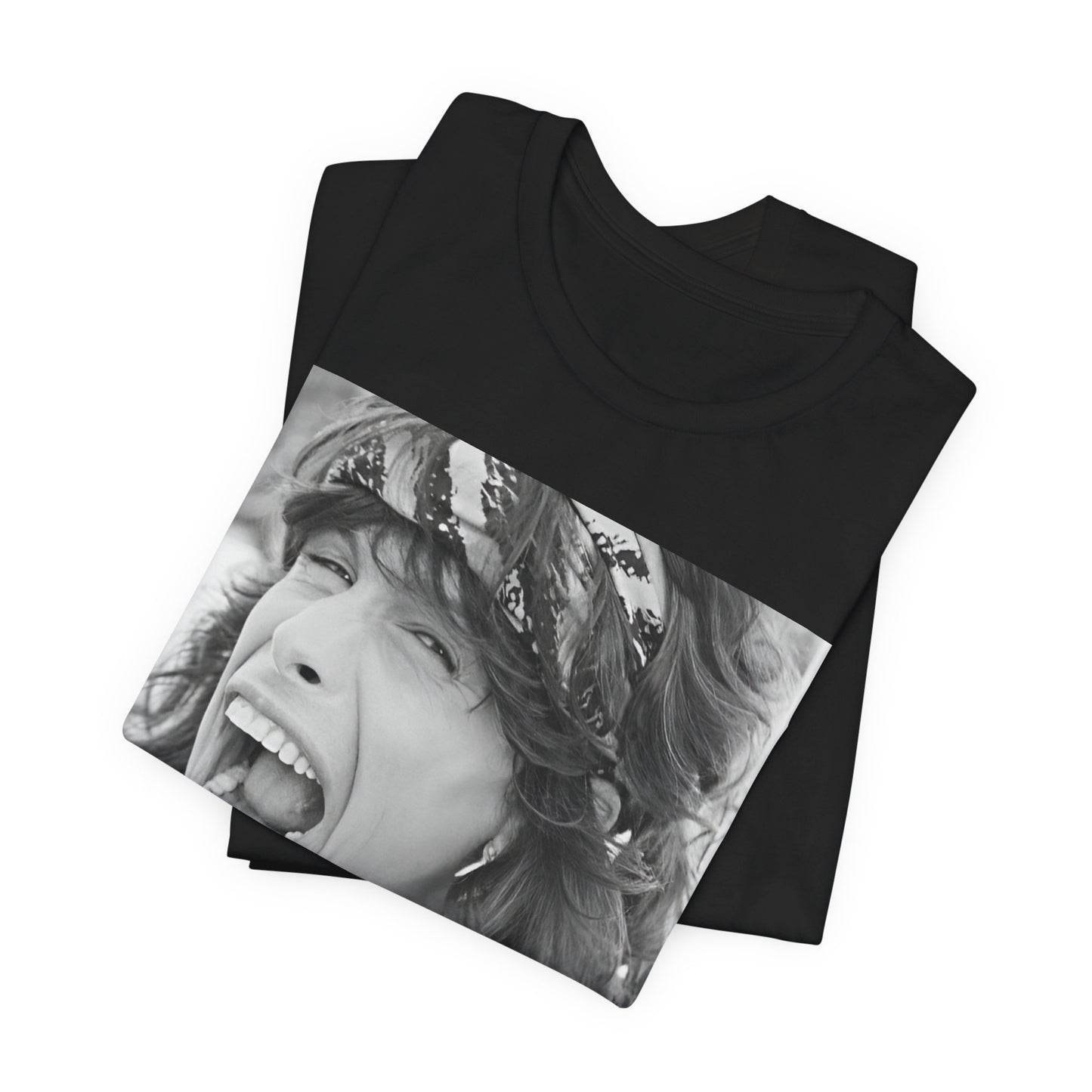 A black graphic t-shirt featuring a candid, dynamic photo of Aerosmith band members on tour in the 1970s, possibly showing action or interaction on stage or backstage.